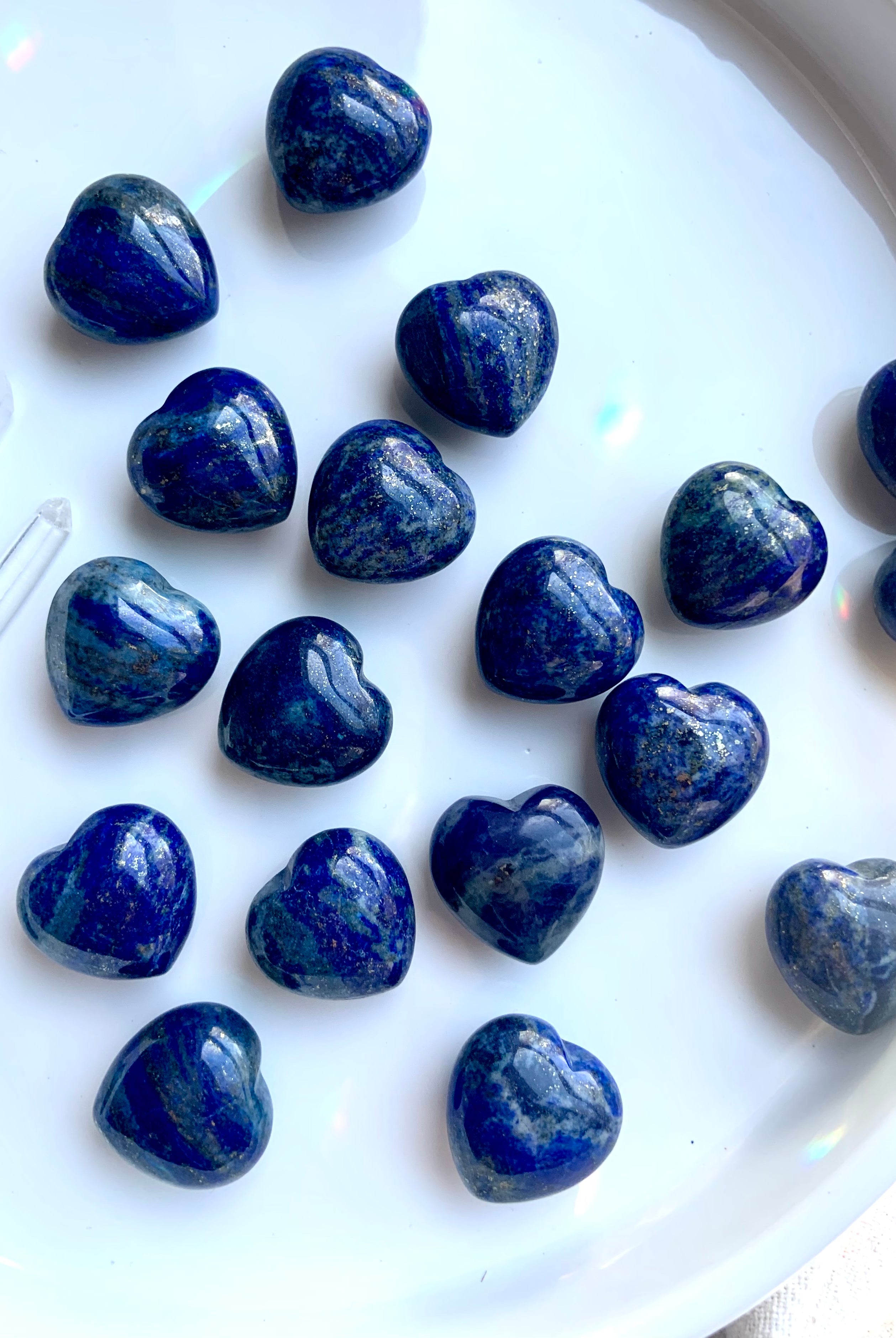 deep blue mini lapis hearts on a white background