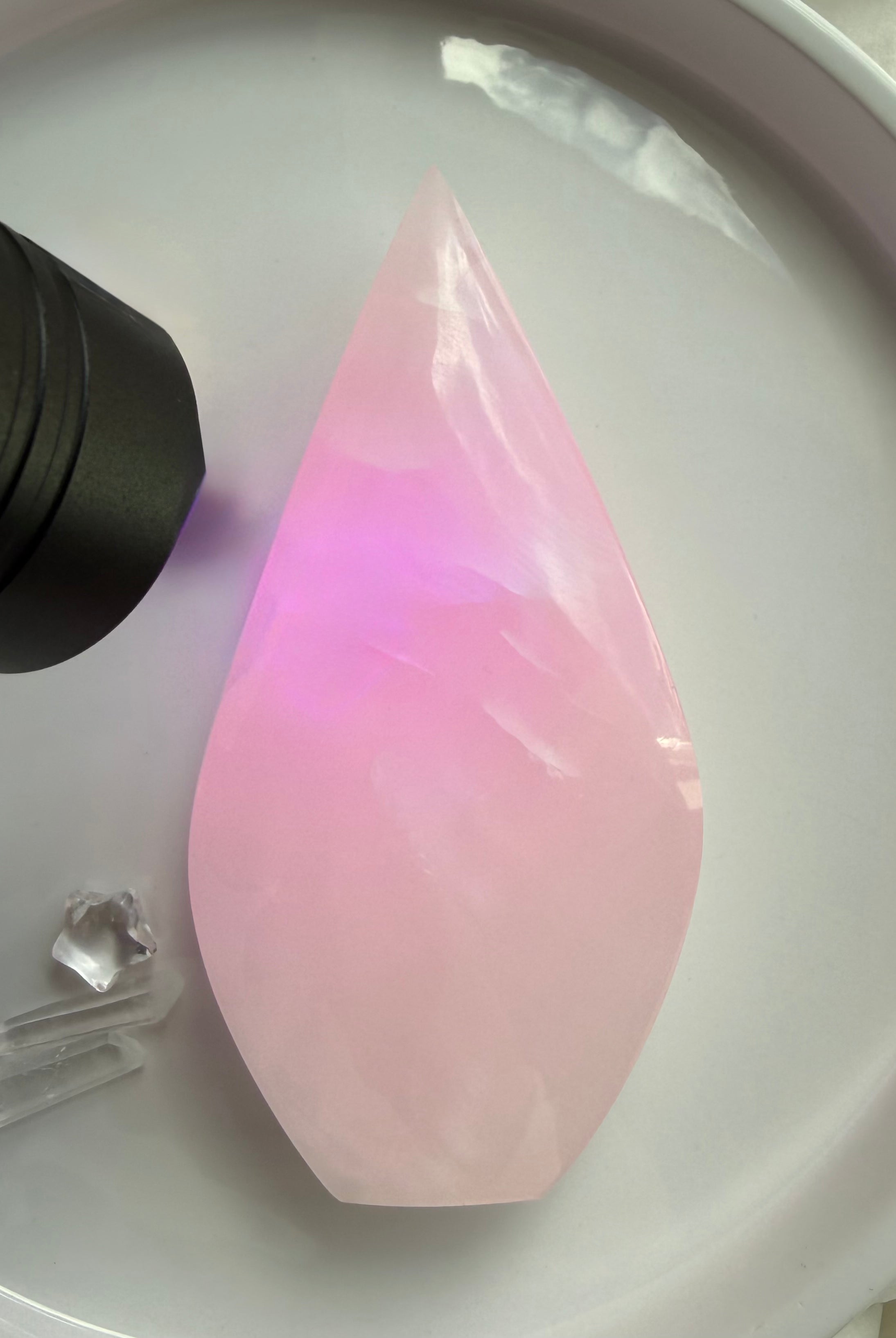UV reactive Mangano Calcite flame glowing bright fluorescent pink under ultraviolet light from Pakistan