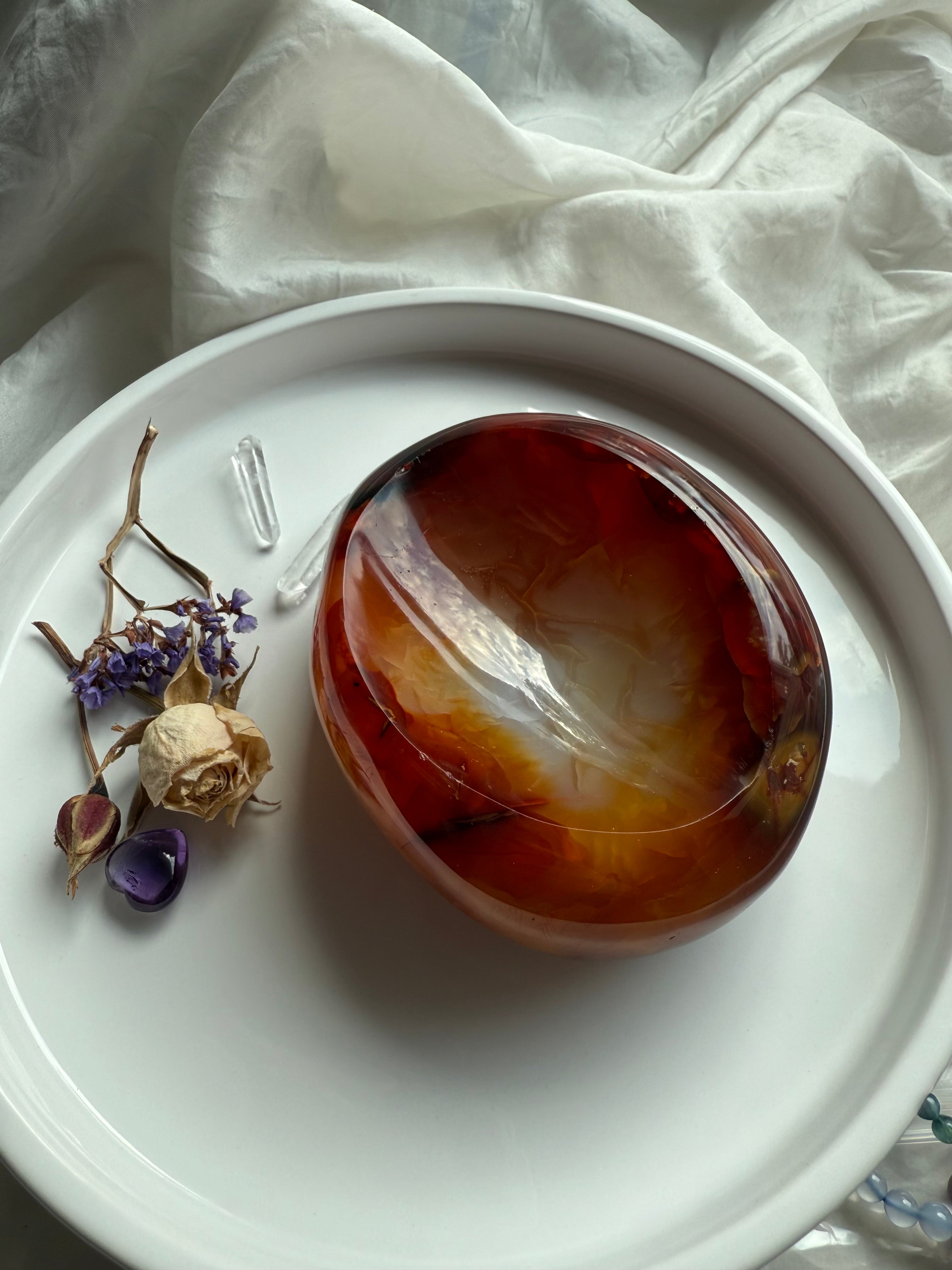 Carnelian crystal bowl with fiery red and orange tones – altar offering dish for passion and creativity