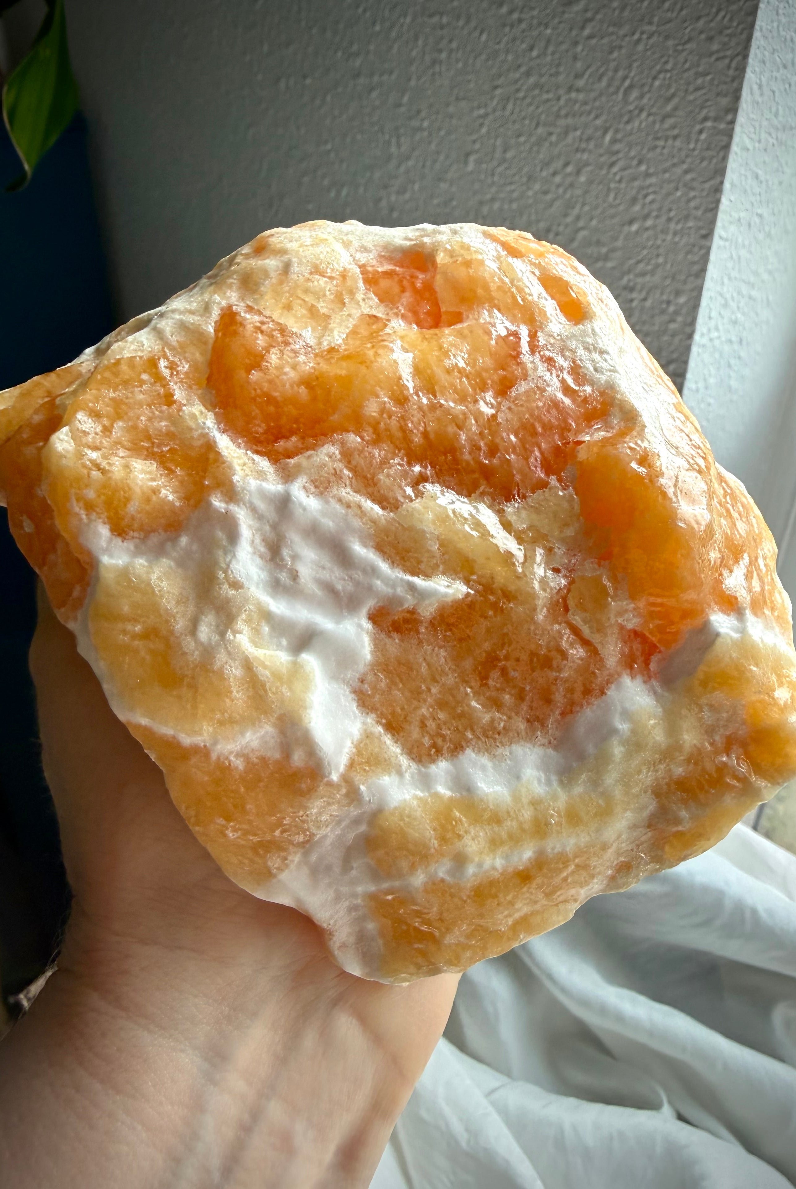 Handheld Orange Calcite specimen with warm uplifting energy and substantial display presence
