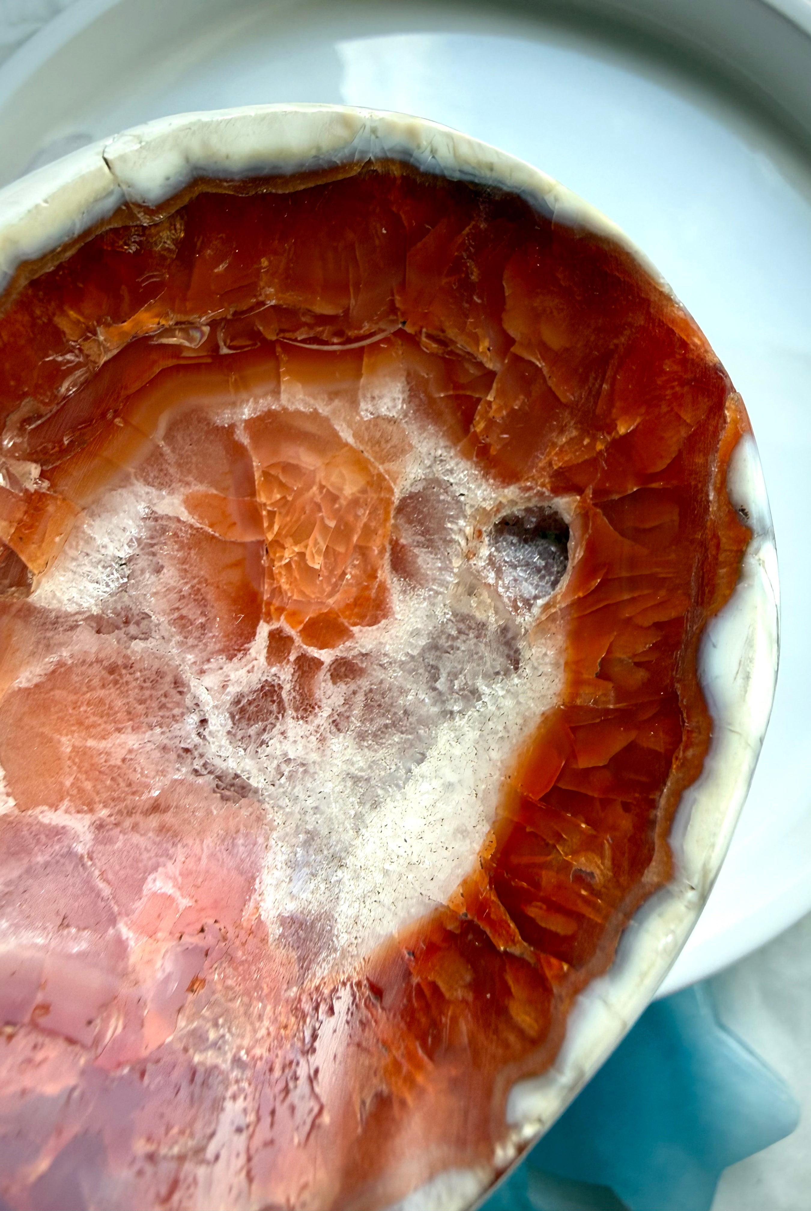 detailed view of polished carnelian stone dish with banding and internal inclusions