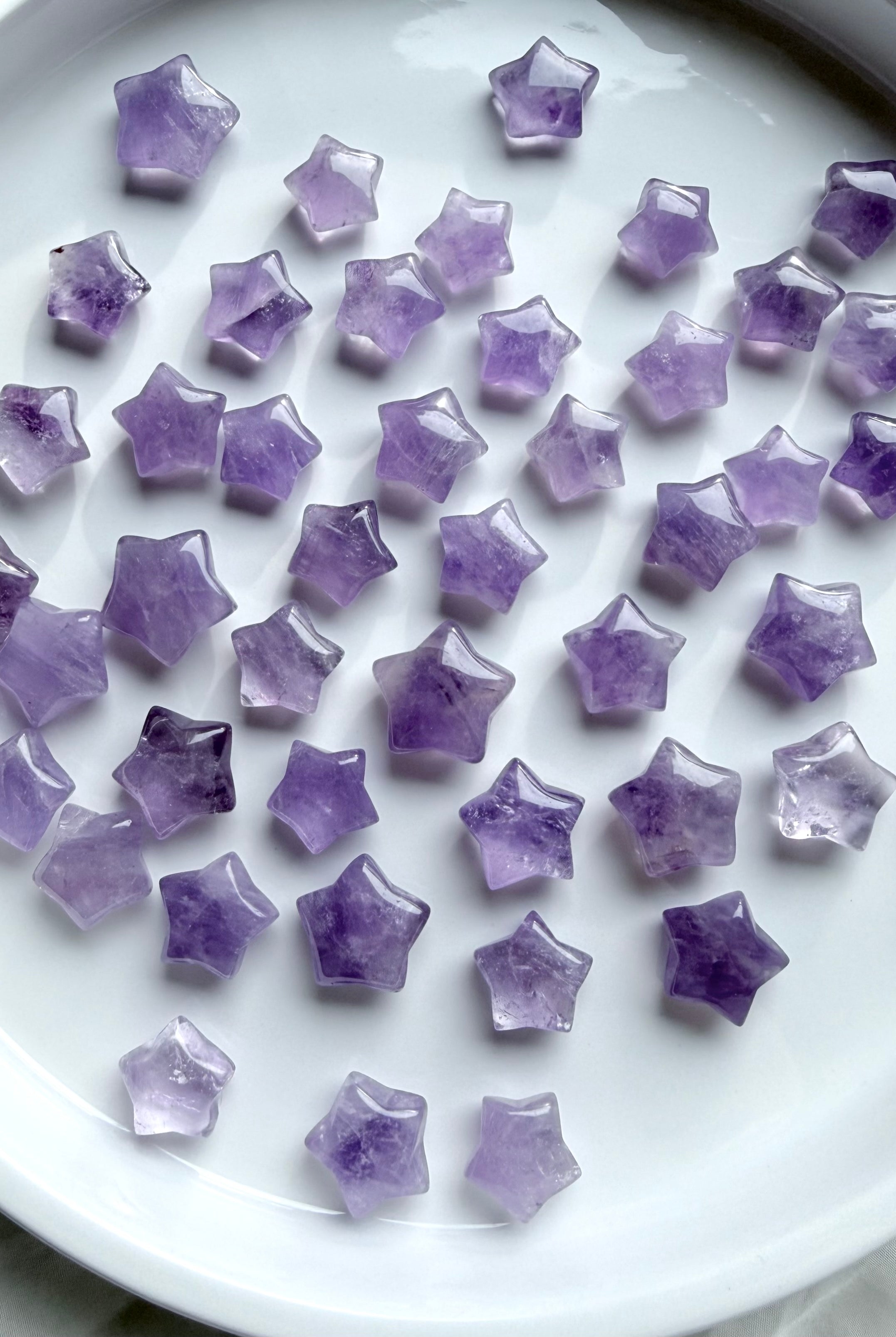 Polished Mini Amethyst star crystals arranged in a white bowl, calming stones for meditation, crystal grids, and spiritual decor