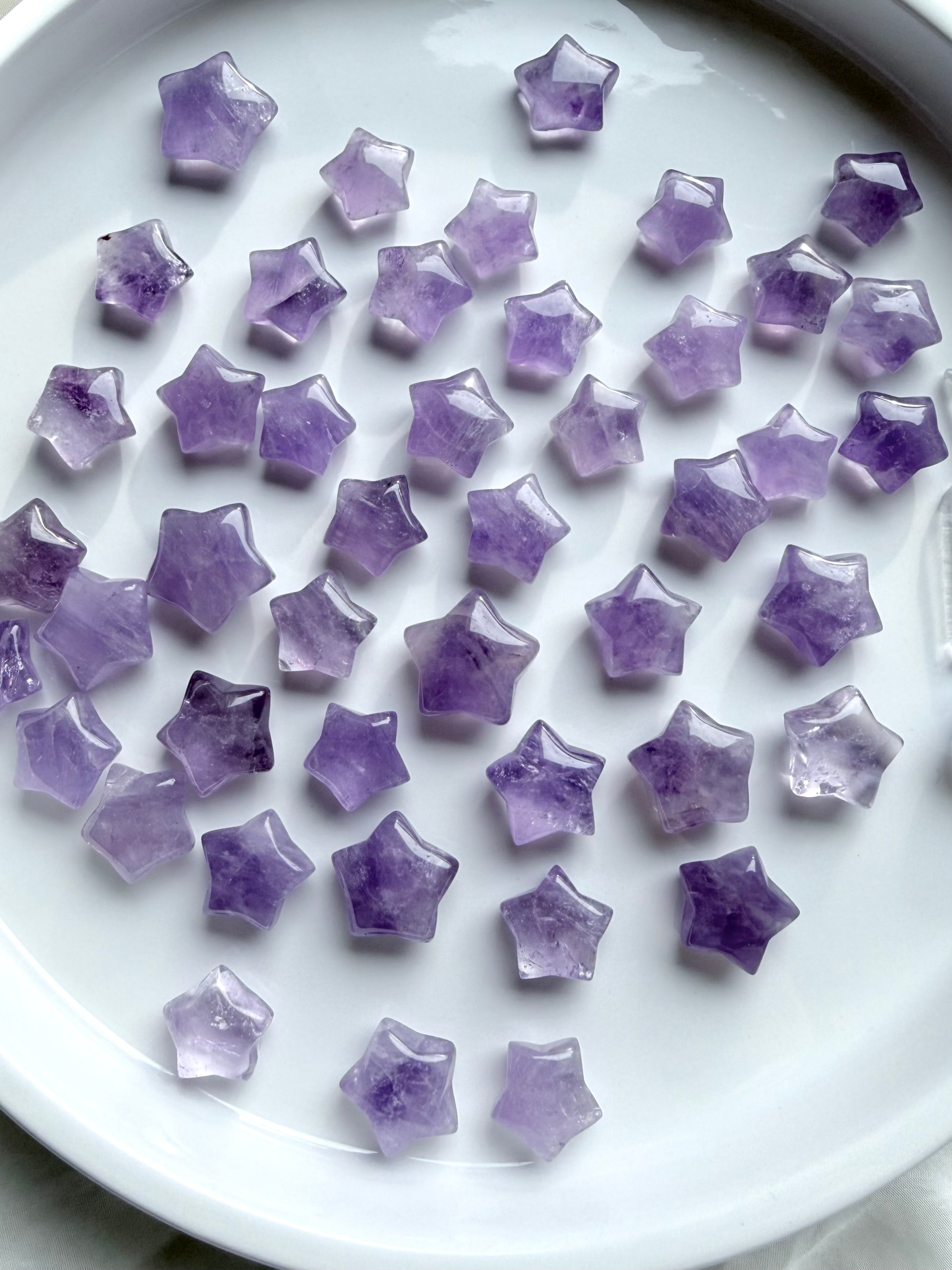 Polished Mini Amethyst star crystals arranged in a white bowl, calming stones for meditation, crystal grids, and spiritual decor