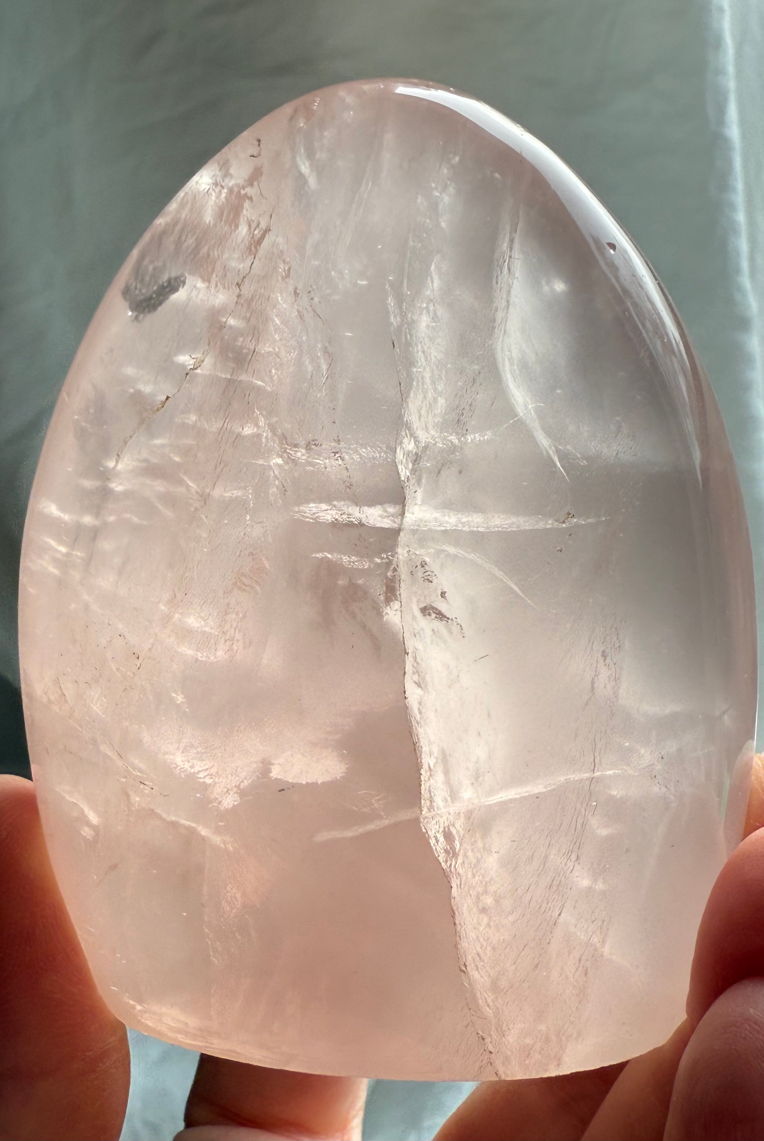Transparent pink Rose Quartz crystal freeform with dreamy glow and polished sculptural shape
