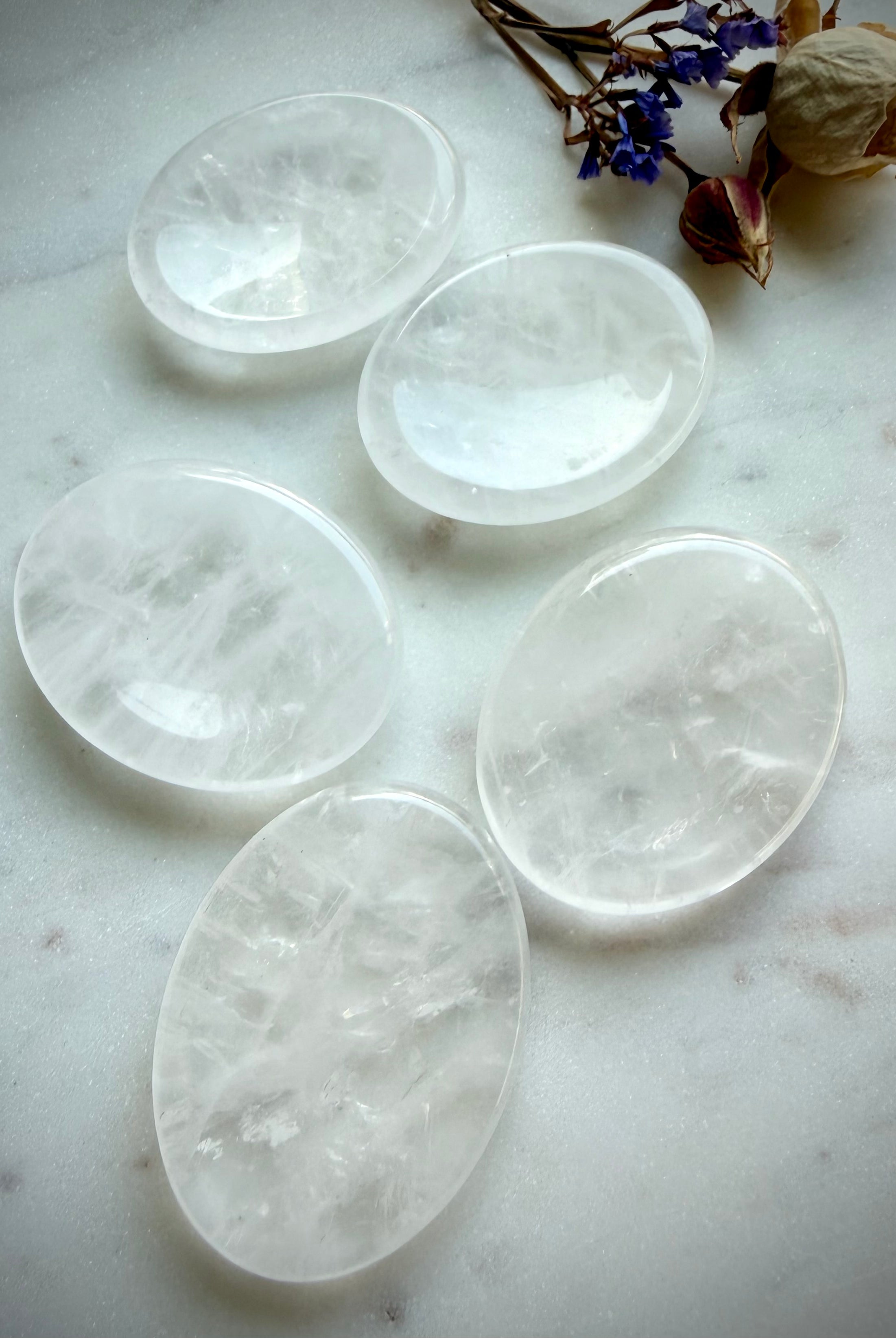 clear quartz oval worry stones on marble surface for clarity focus and calming energy