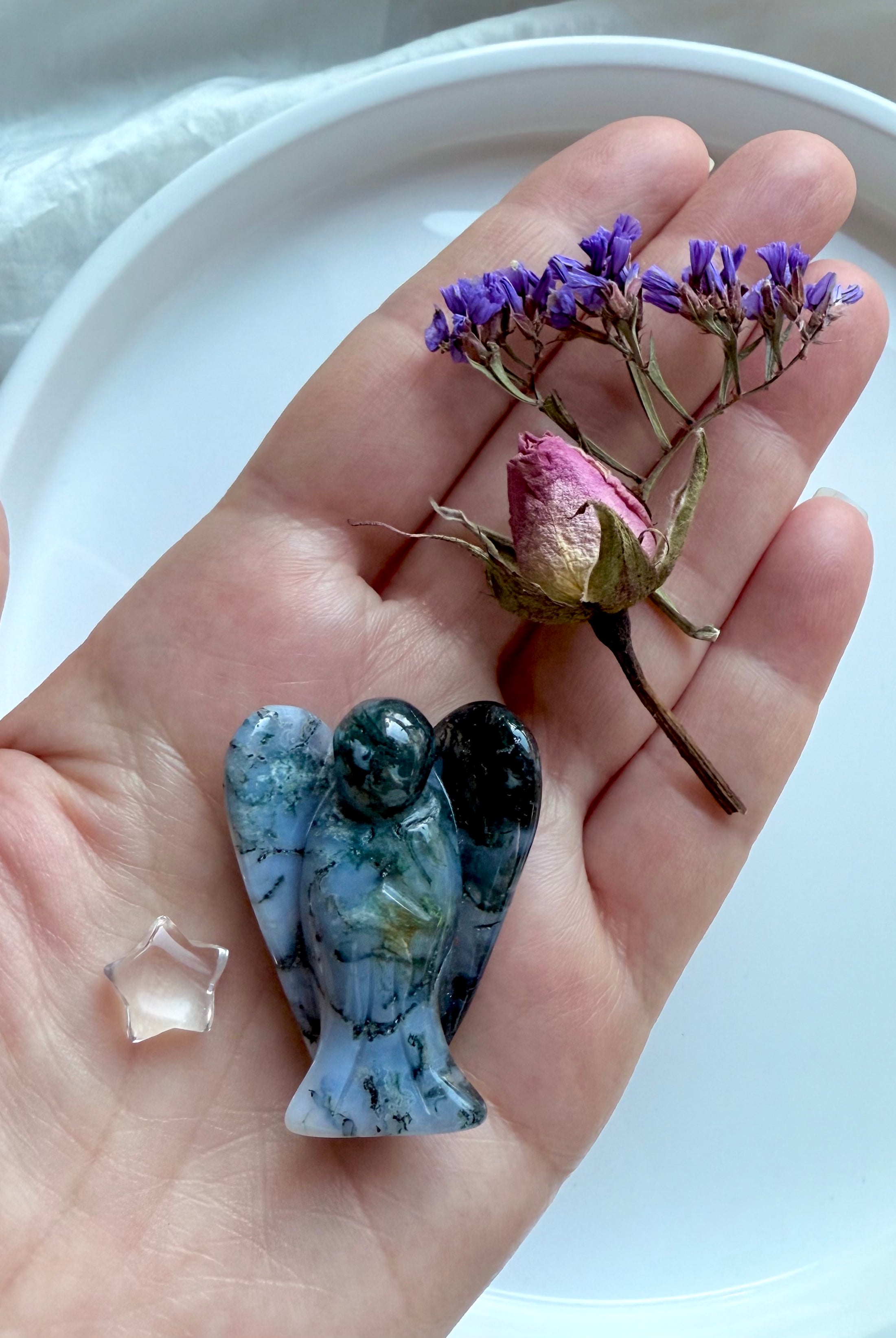 Moss Agate crystal angel figurine, tiny clear quartz star, and mini dried flower bouquet resting on open hand – grounding healing gift set