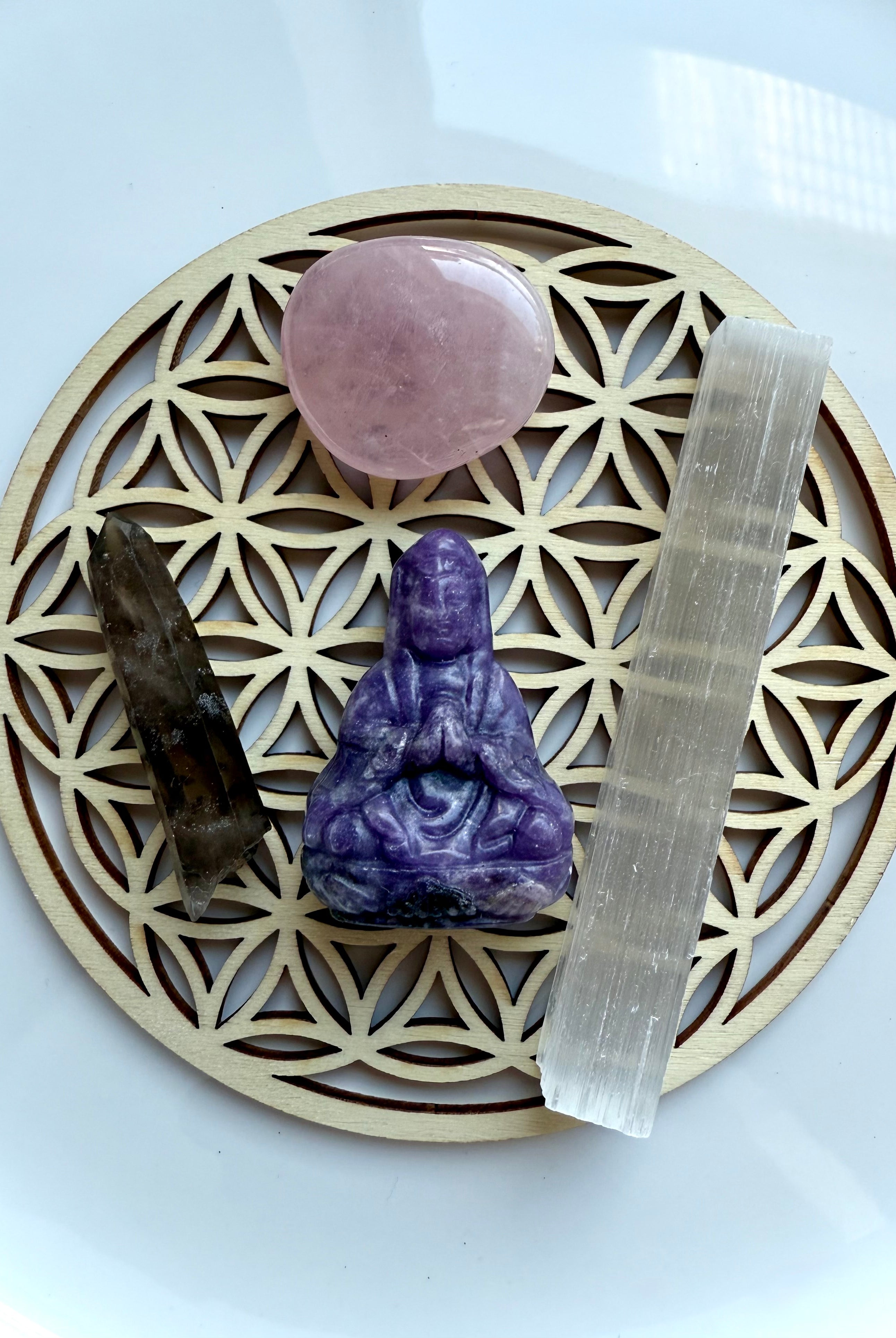 Crystal arrangement of Lepidolite Quan Yin, rose quartz, smoky quartz + selenite on wooden Flower of Life grid – sacred travel altar set for peace and protection