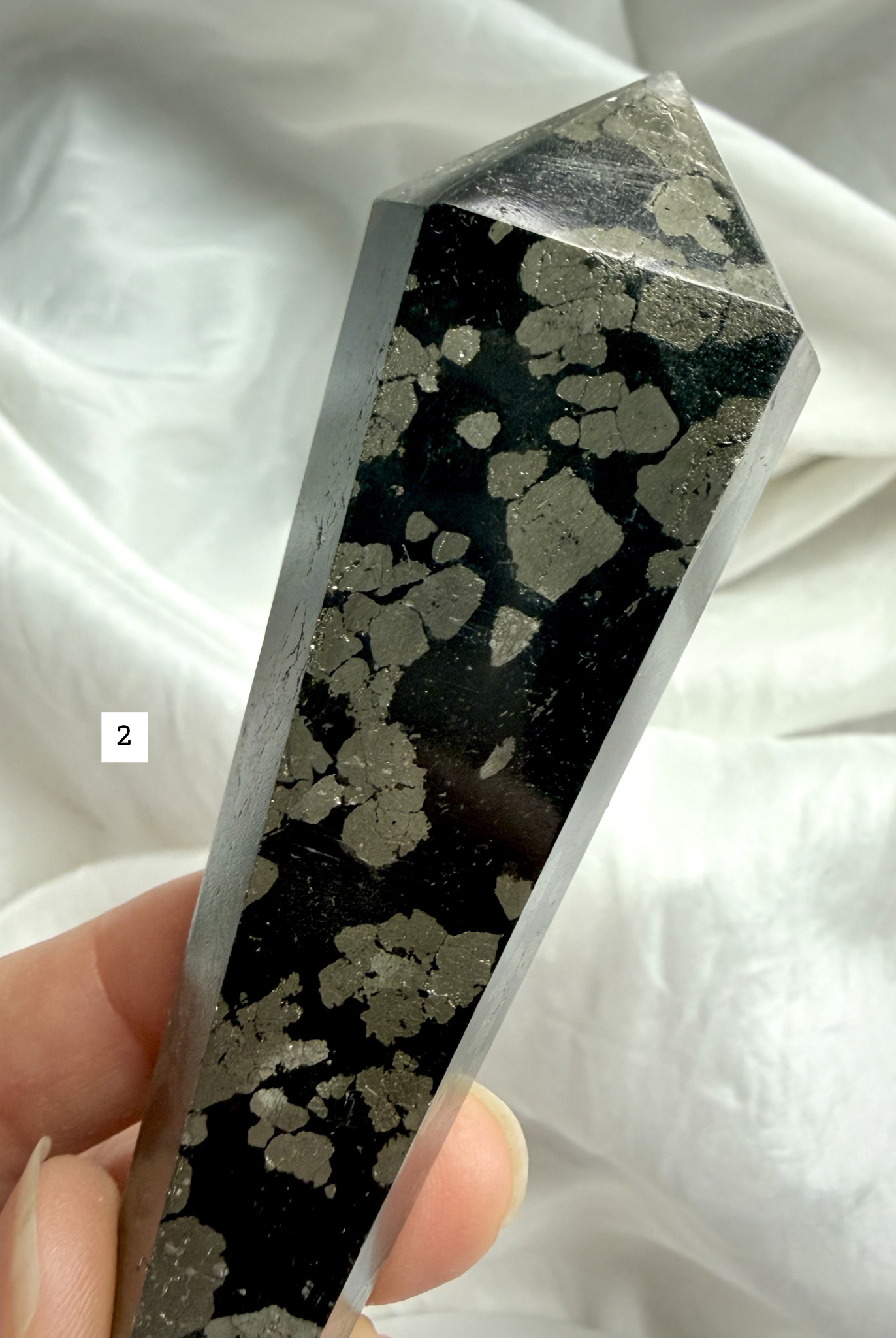 pyrite in black matrix crystal point close up showing natural mineral pattern
