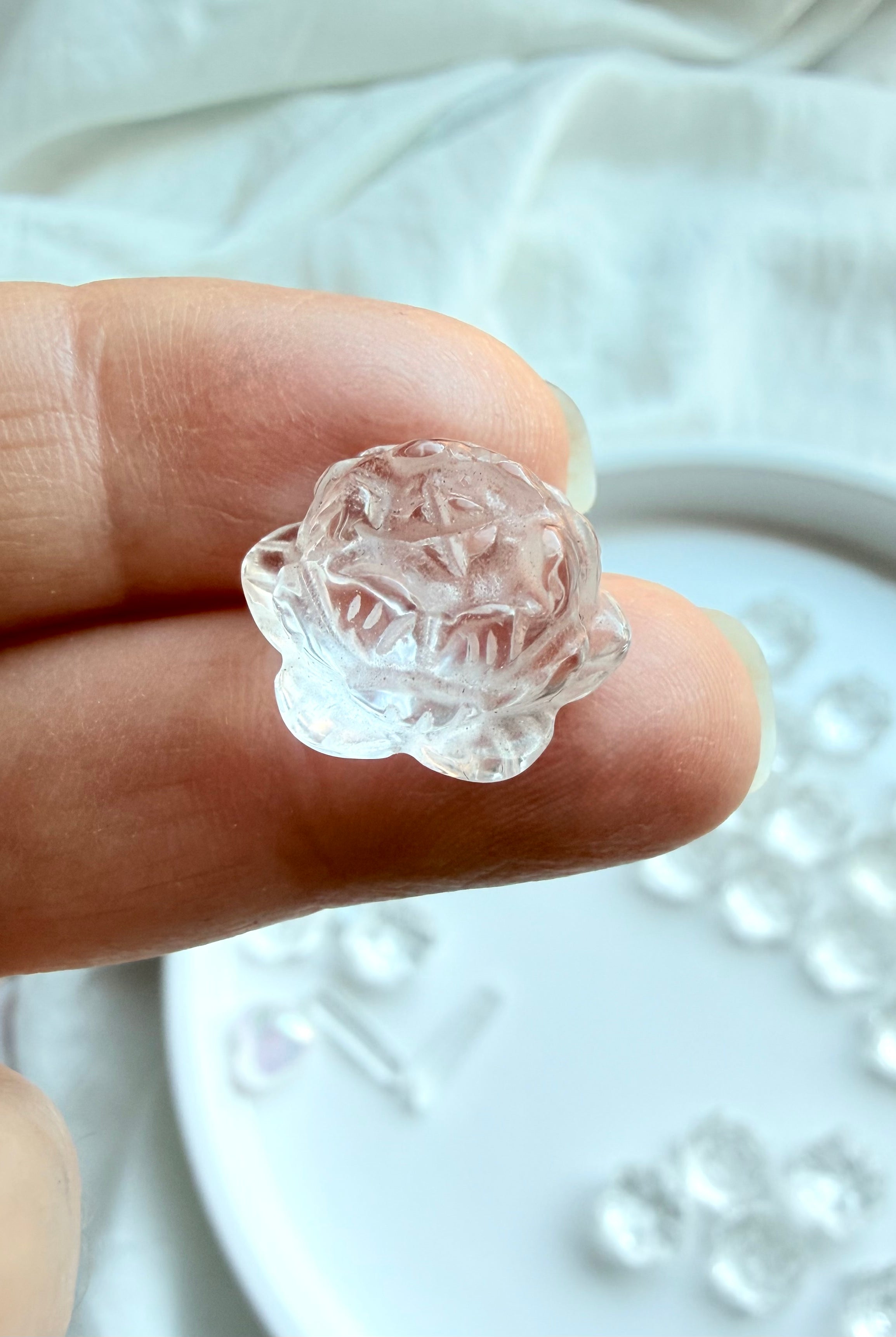 Clear Quartz mini lotus flower crystal carving, angled view with polished layered petals and natural clarity