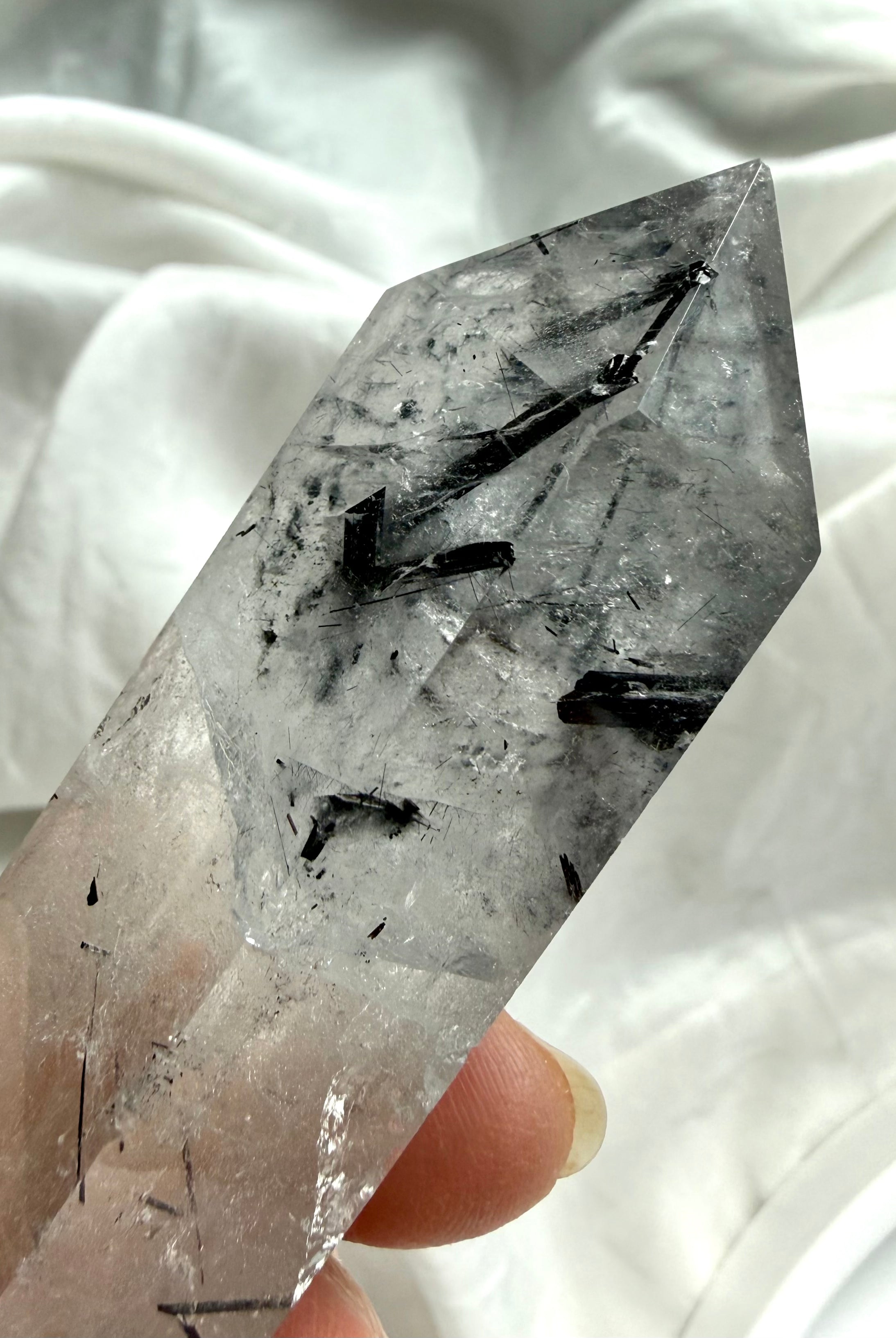 double terminated quartz crystal end detail with natural black tourmaline inclusions