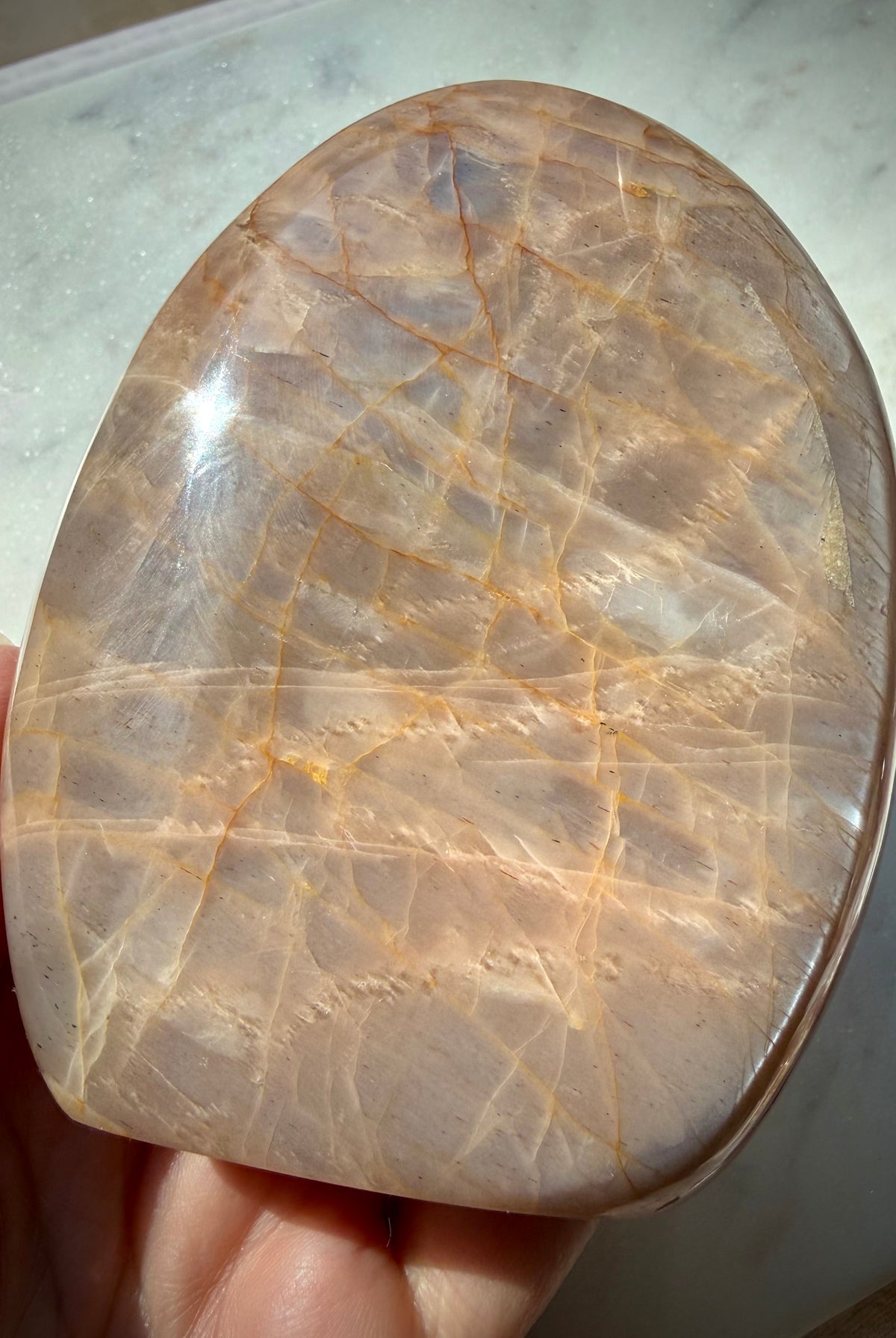 Peach Moonstone freeform reverse side showing soft silver shimmer, warm orange peach tones and natural mineral patterns