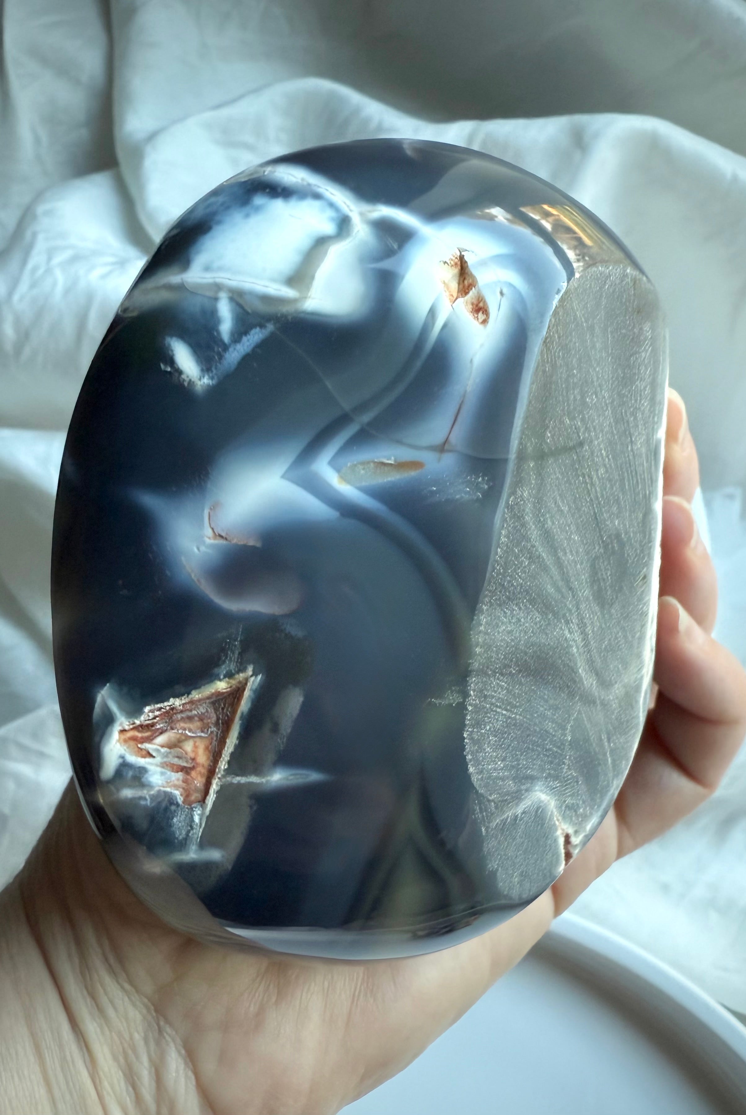 Orca Agate offering bowl showing deep blue-grey banding with a natural exposed druzy pocket and polished edges — grounding crystal bowl for calm, protection, and ritual use.