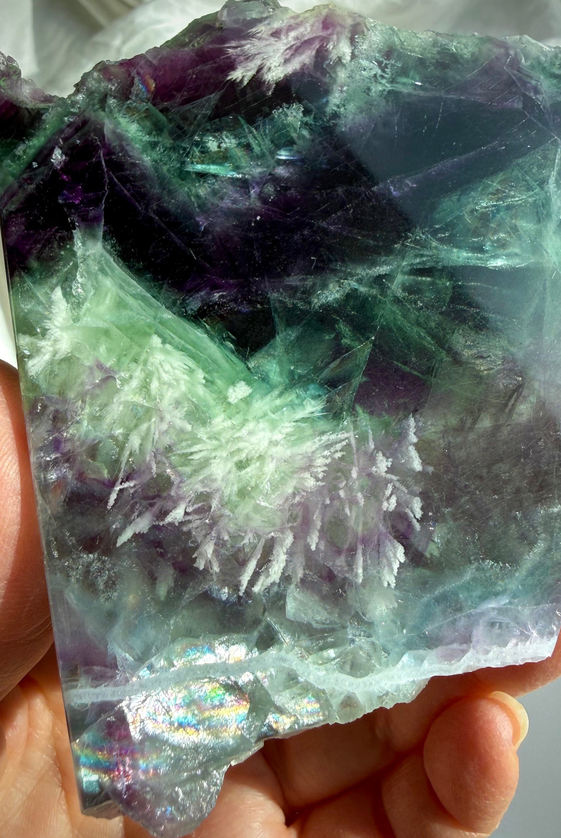 Detail view of one of a kind fluorite slab with scolecite inclusions, smooth polished face, and natural crystal patterns