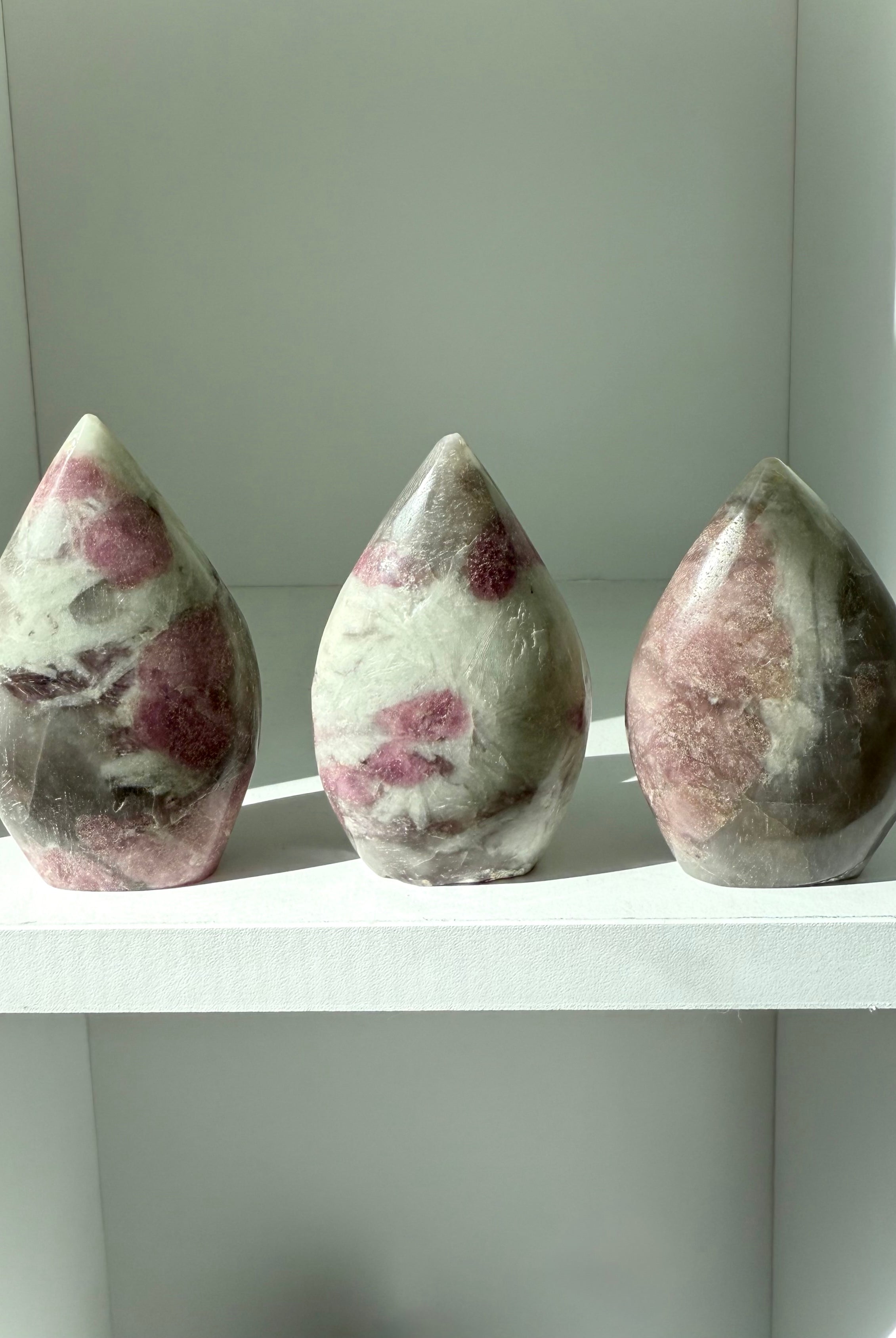 Unicorn Stone carvings in flame shapes — rare gemstone with pink tourmaline and lepidolite inclusions