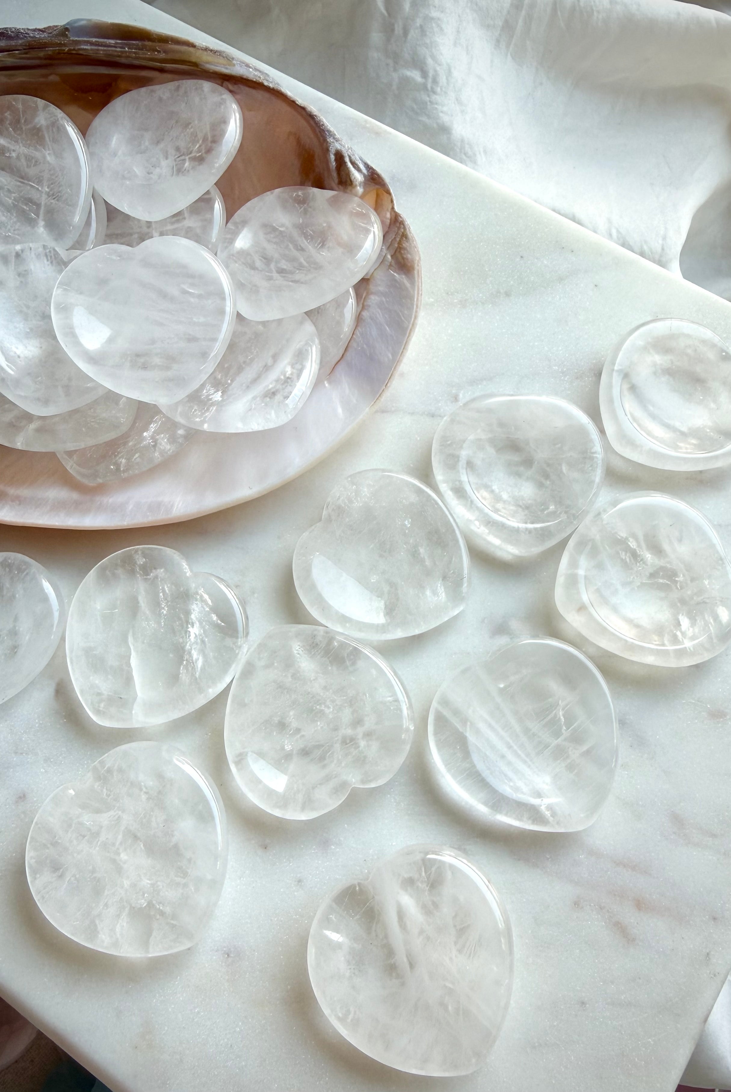 clear quartz heart worry stones on dish on marble for clarity energy and chakra healing