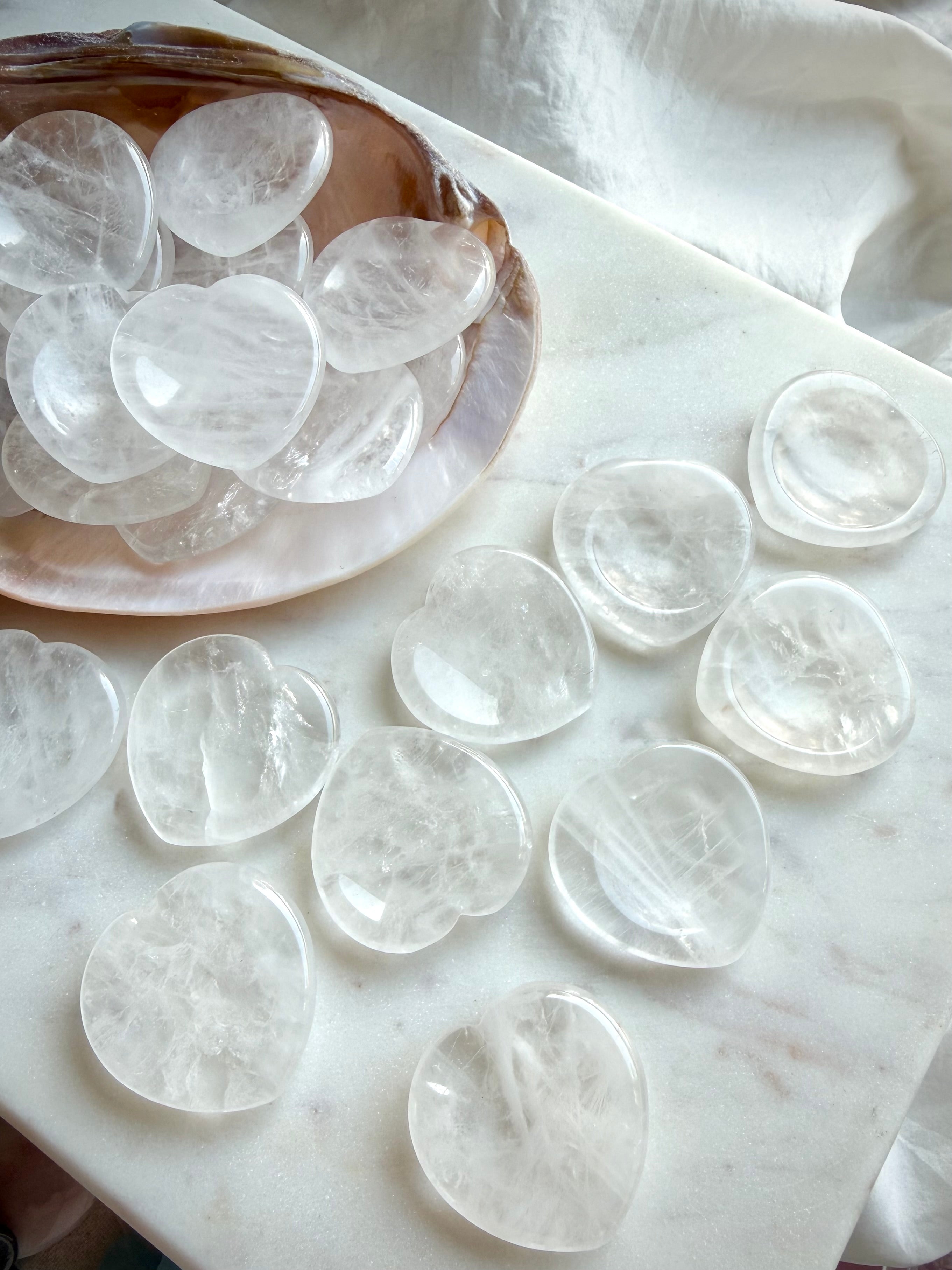 clear quartz heart worry stones on dish on marble for clarity energy and chakra healing