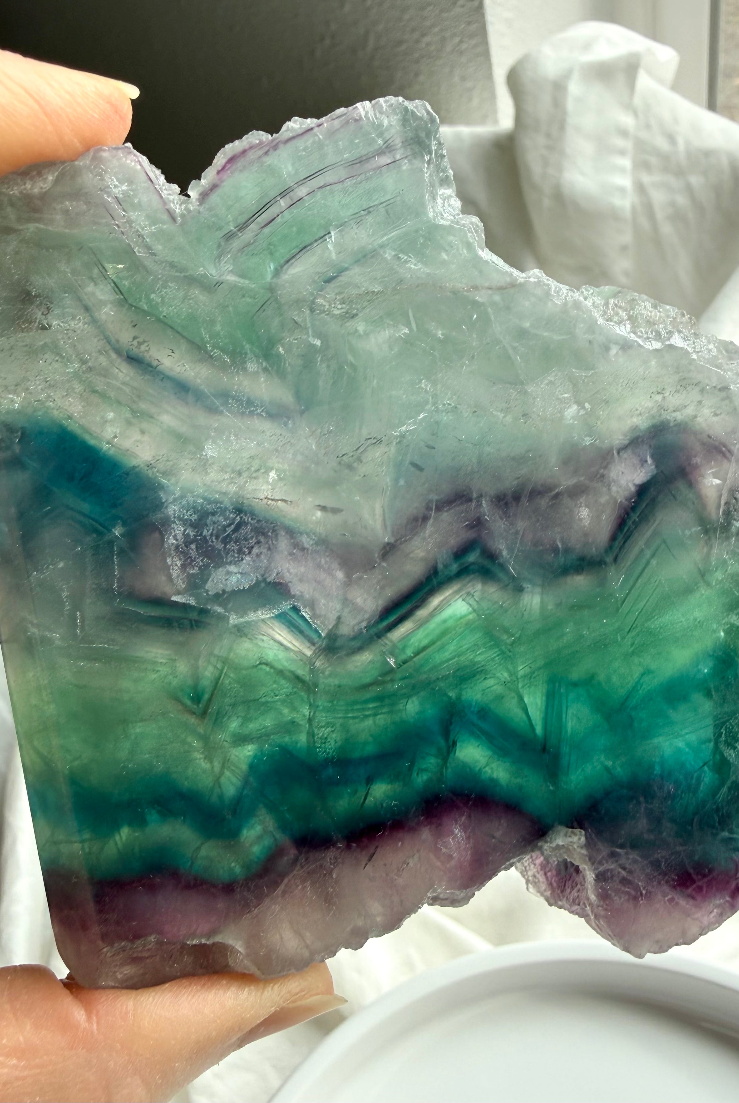 One of a kind fluorite slab shown in hand for size reference