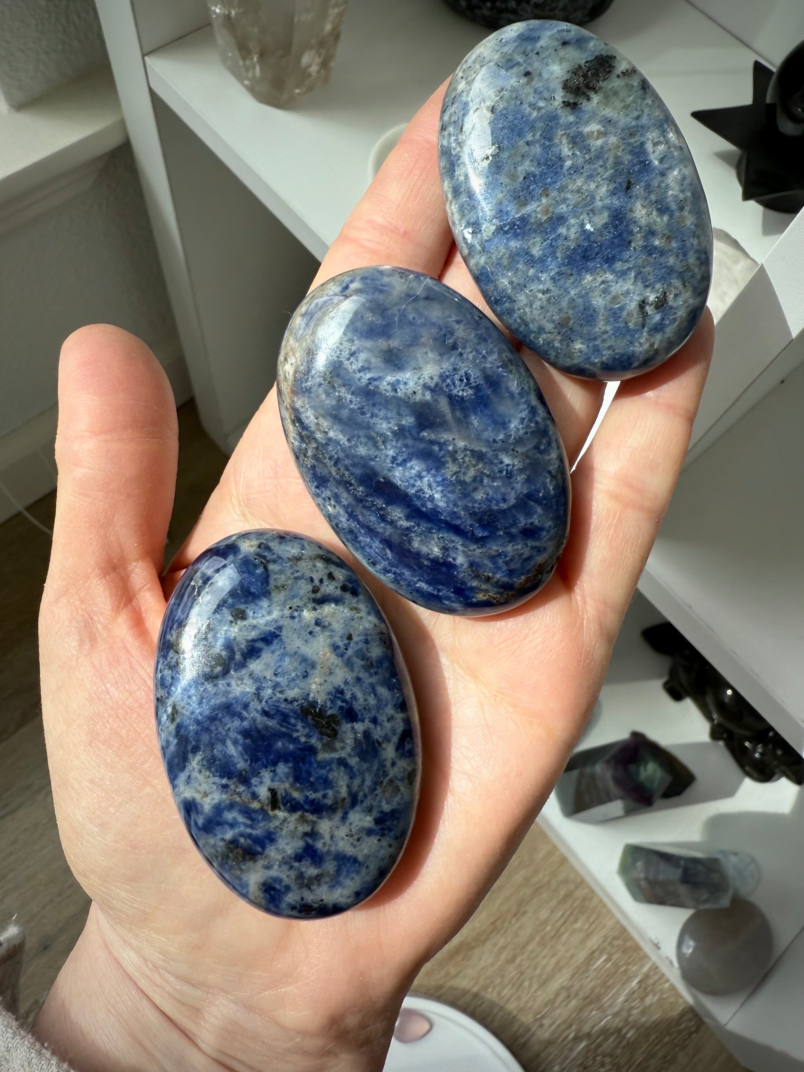 High quality blue Sodalite Palmstones shown on my hand for scale, photographed in natural light
