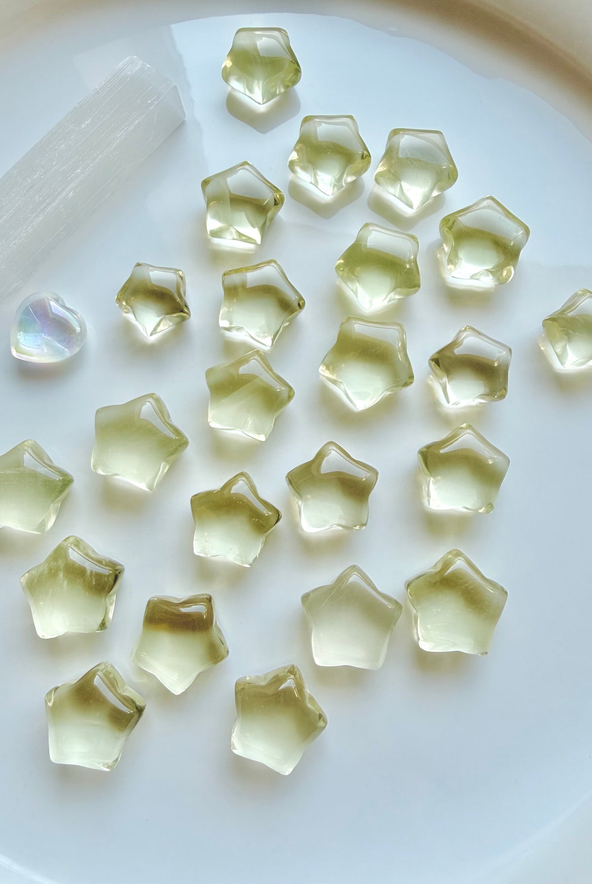 Mini Lemon Citrine stars in two sizes showing their clear, translucent lemon-yellow color