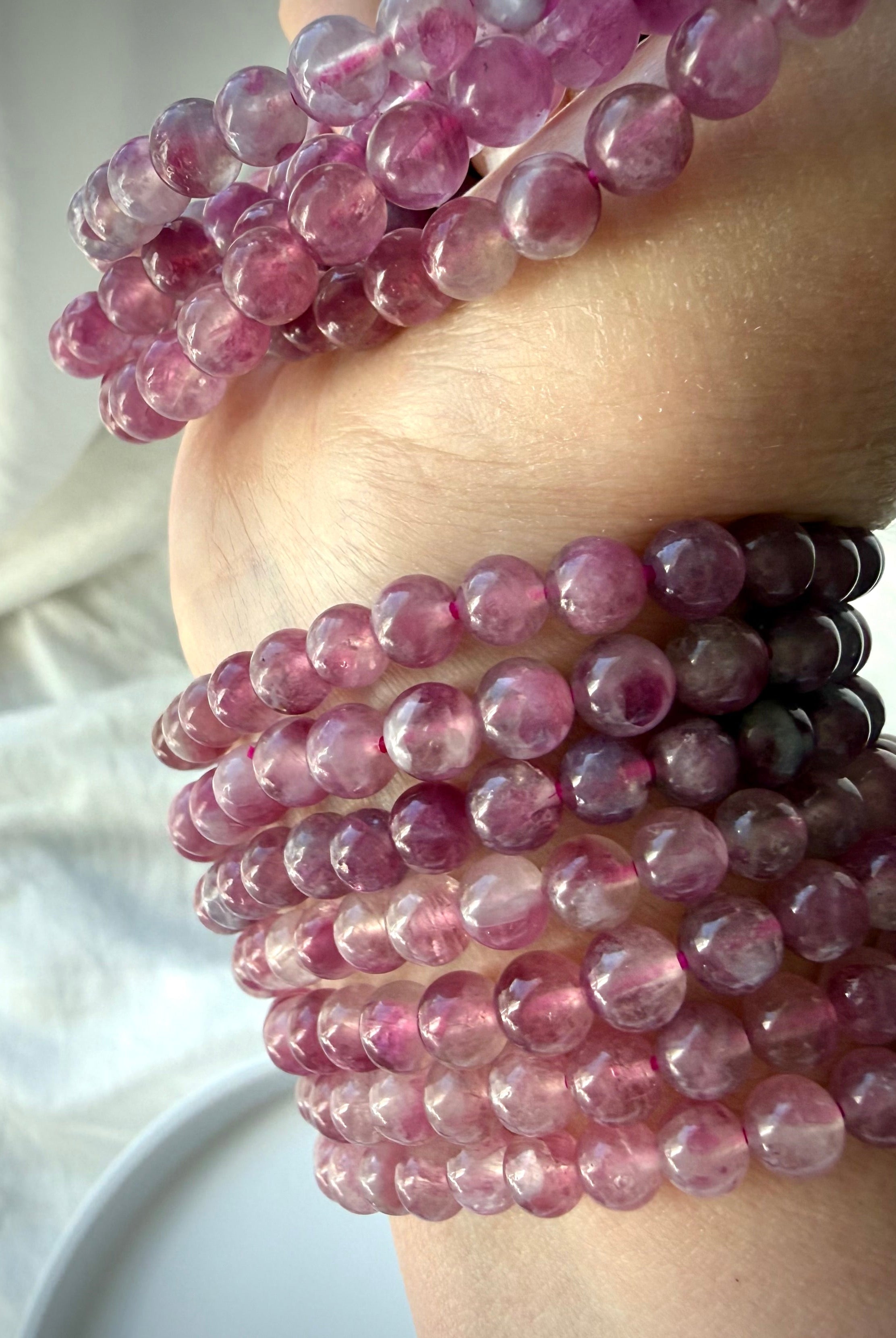 Pink Tourmaline bracelet collection showcasing natural color variation from blush pink to rich berry tones with beautiful translucency