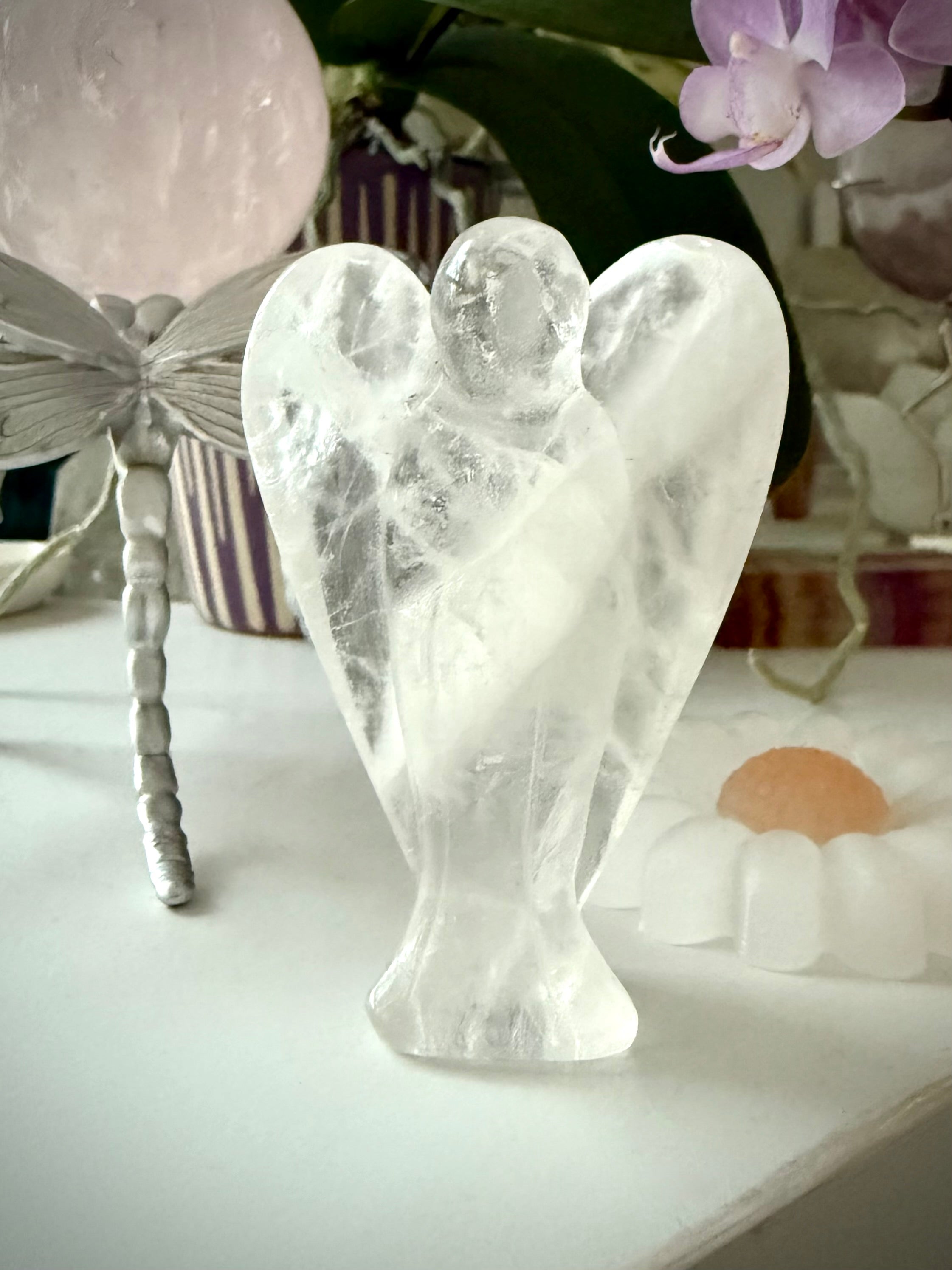 a one of a kind guardian angel hand-carved from natural clear quartz crystal to display in your home