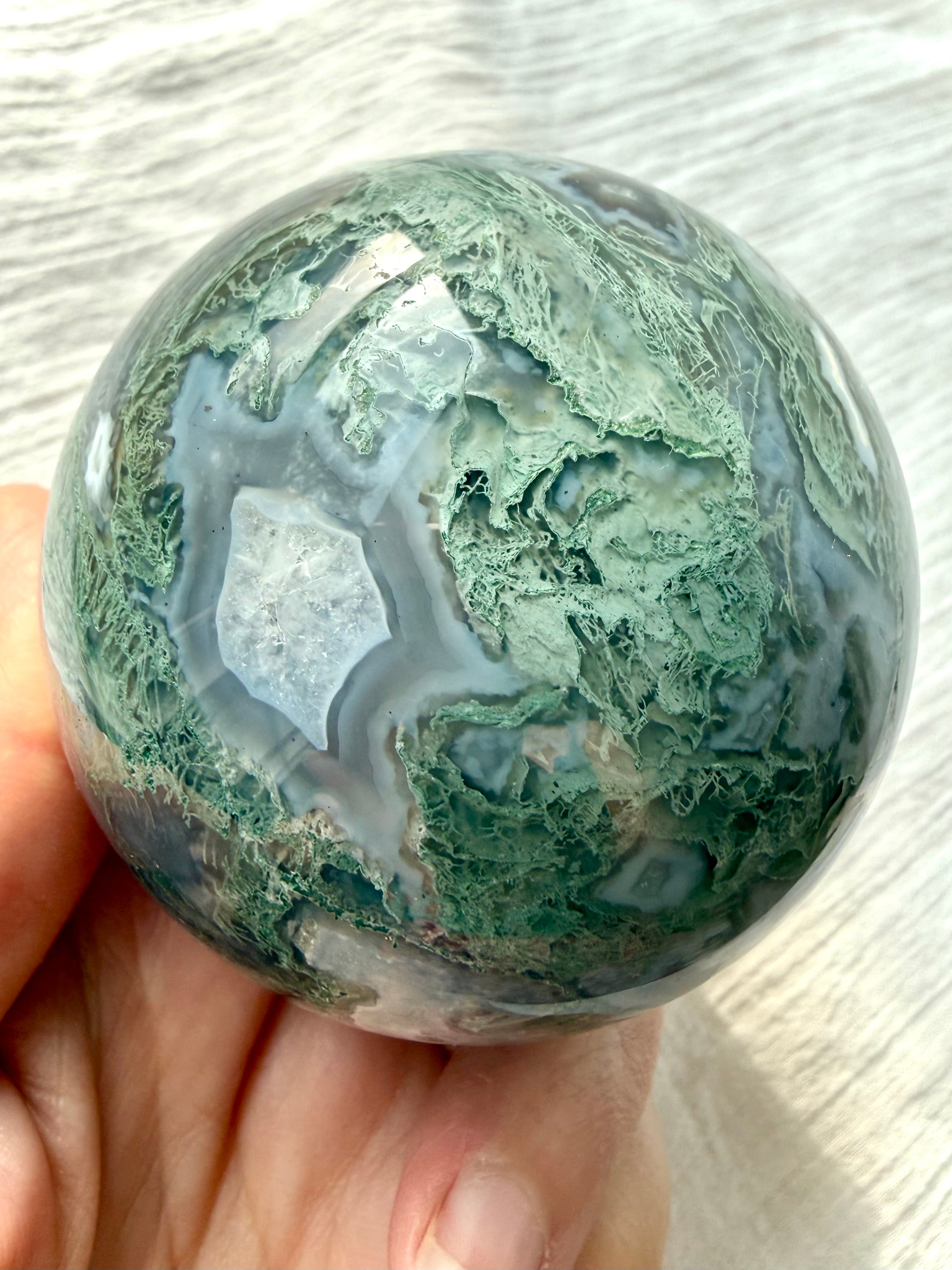 Moss Agate crystal sphere with painterly white agate, gray chalcedony and mossy green inclusions