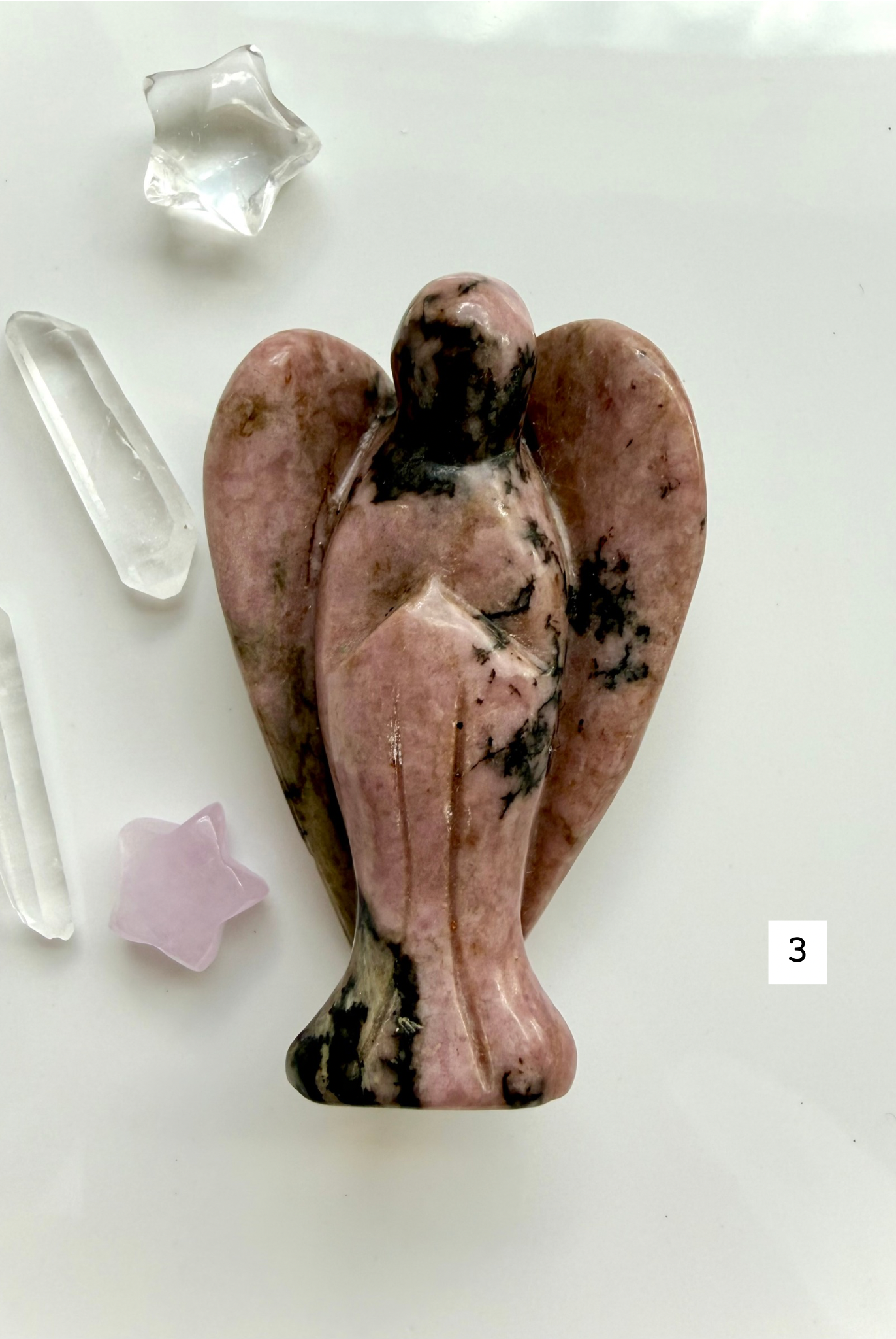 Natural Rhodonite crystal guardian angel with rosy coloring and polished wings for emotional balance
