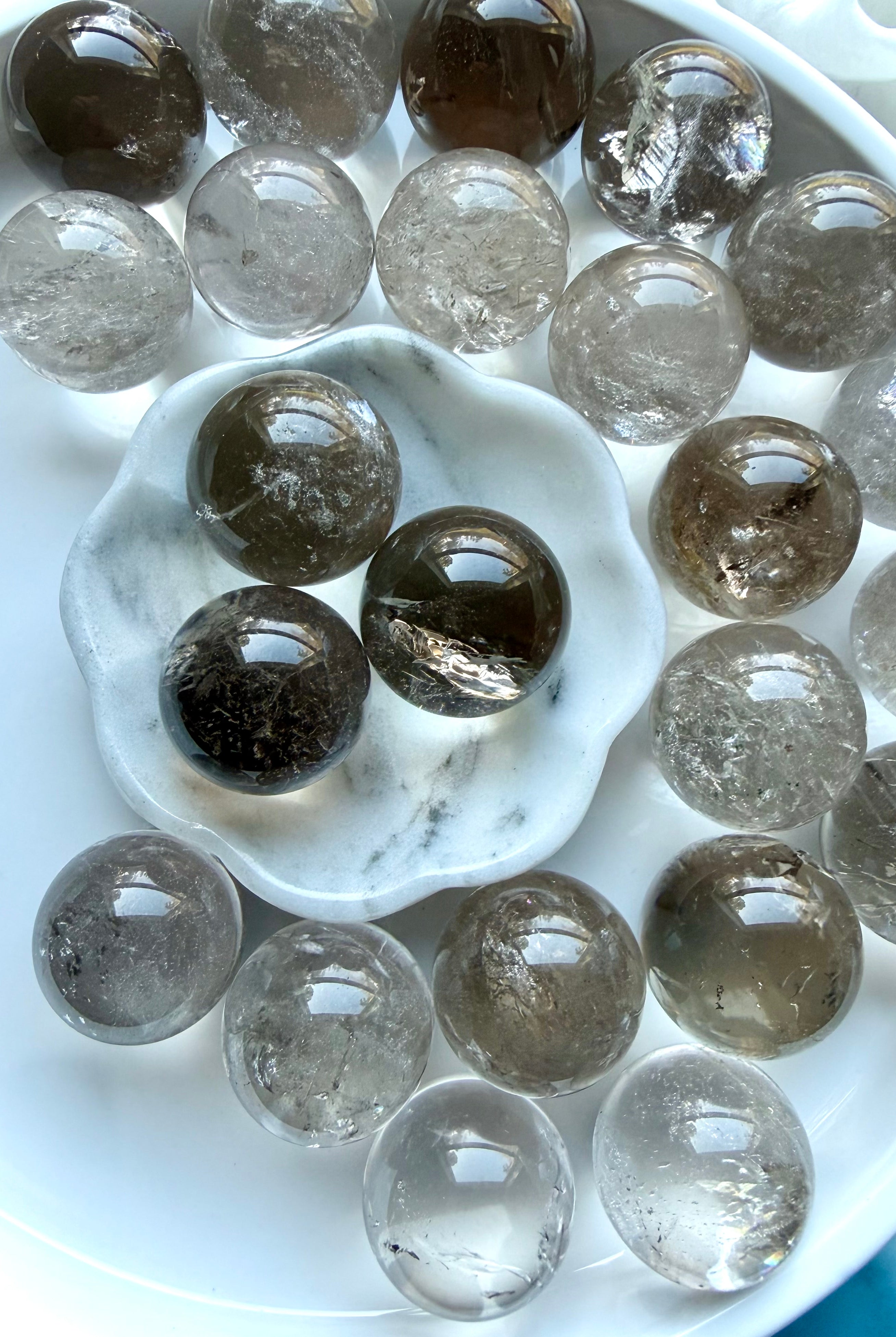 Overhead view of Smoky Quartz mini crystal spheres with glossy polish and natural color variation