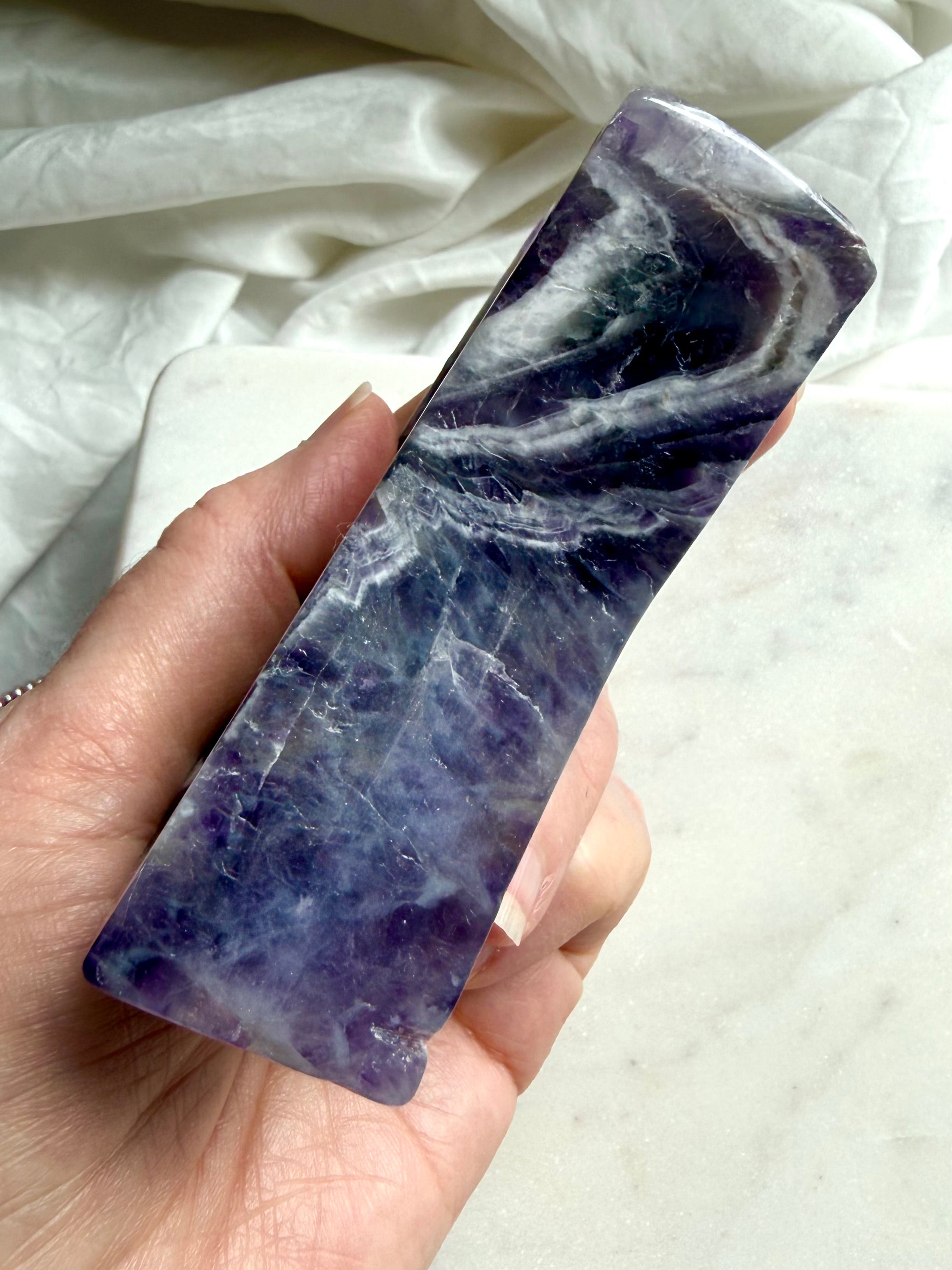 Close-up of Dream Amethyst crescent bowl edge showing natural inclusions and polished surface texture