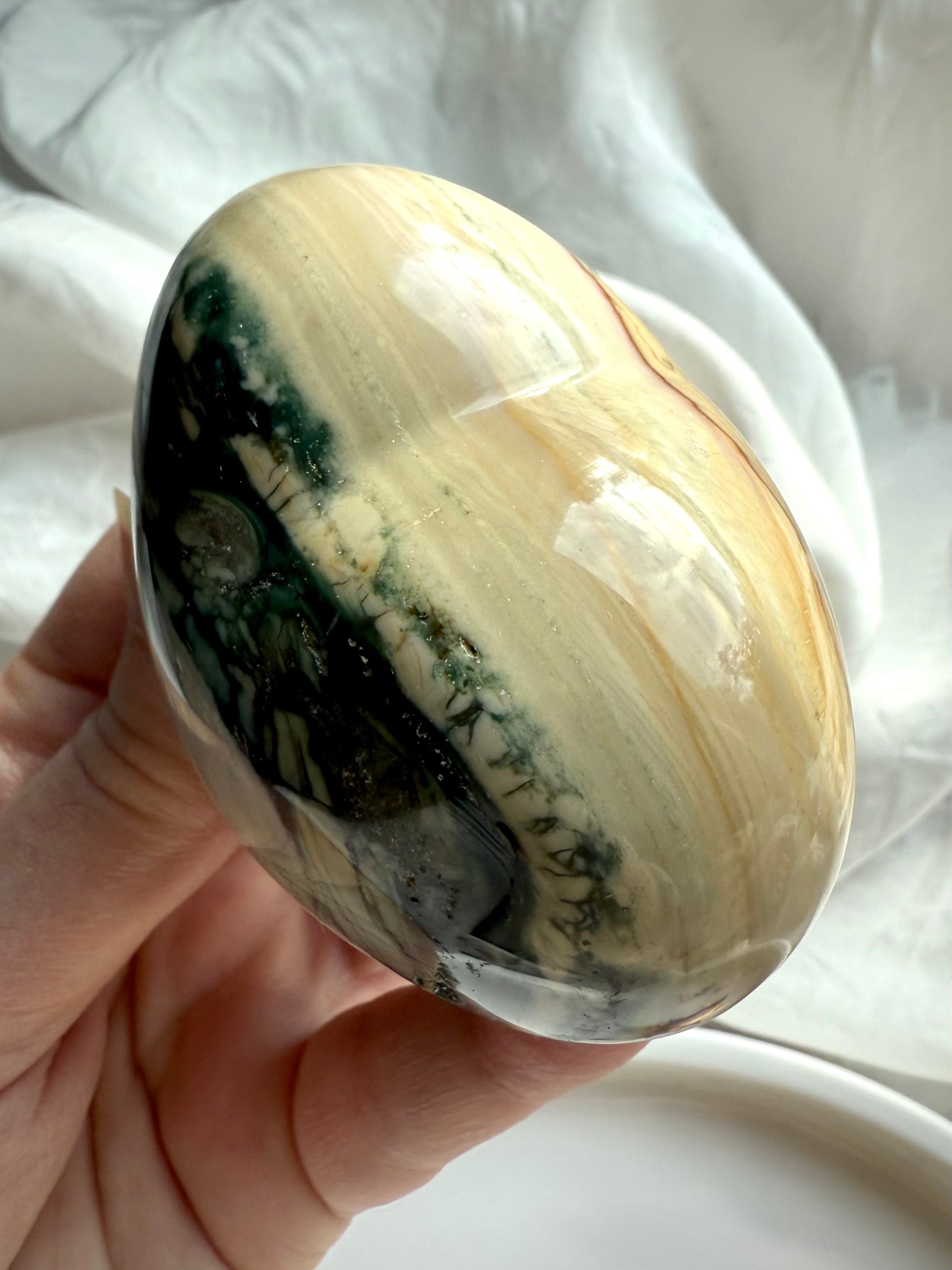 Top view of an Ocean Jasper heart showing the layers of color from soft sandy beige to deep forest green