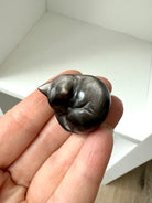 This tiny Silver Sheen Obsidian Sleeping Cat offers energetic protection to your sacred space.