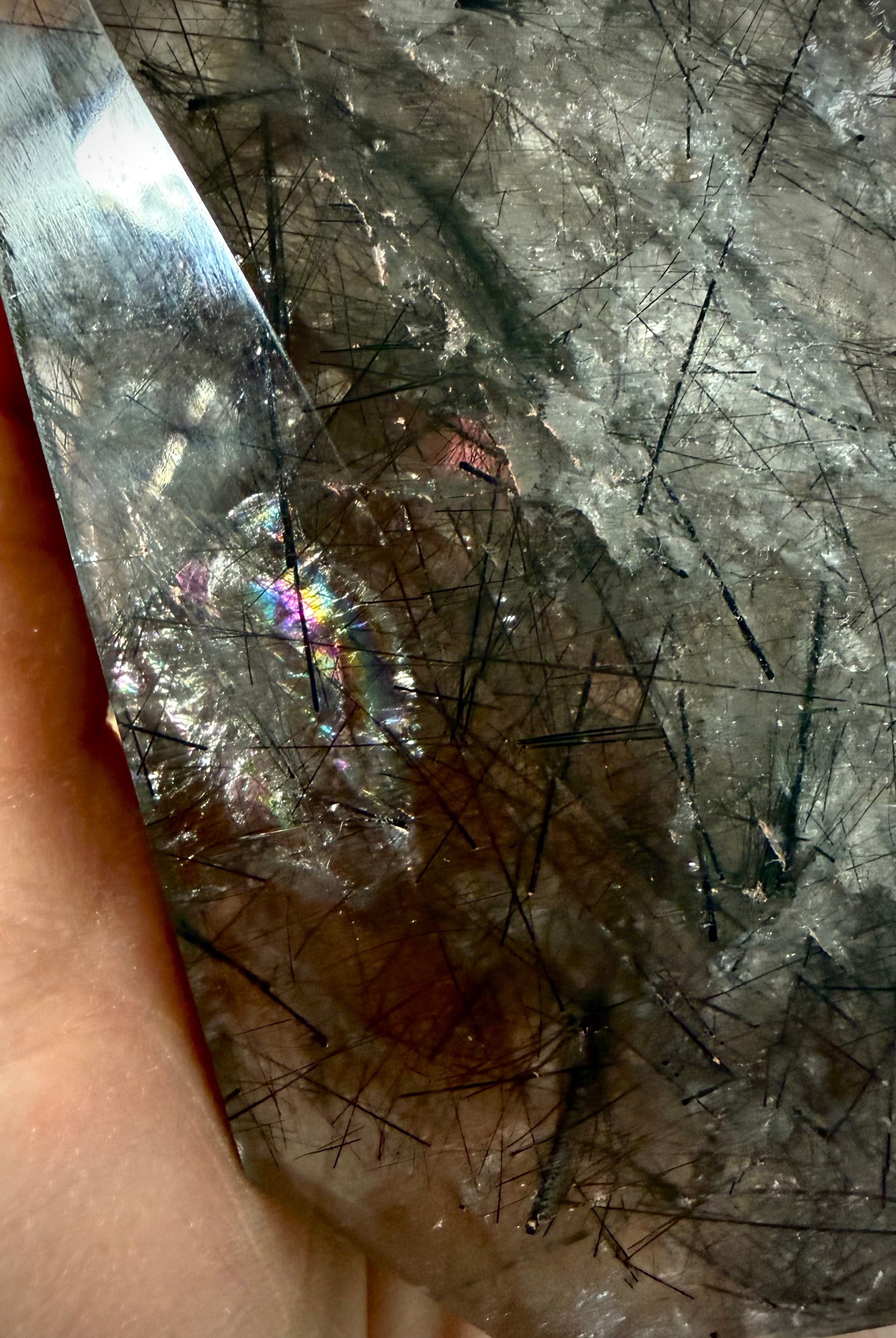Rainbow flash inside Black Tourmaline in Quartz crystal with polished faceted surface