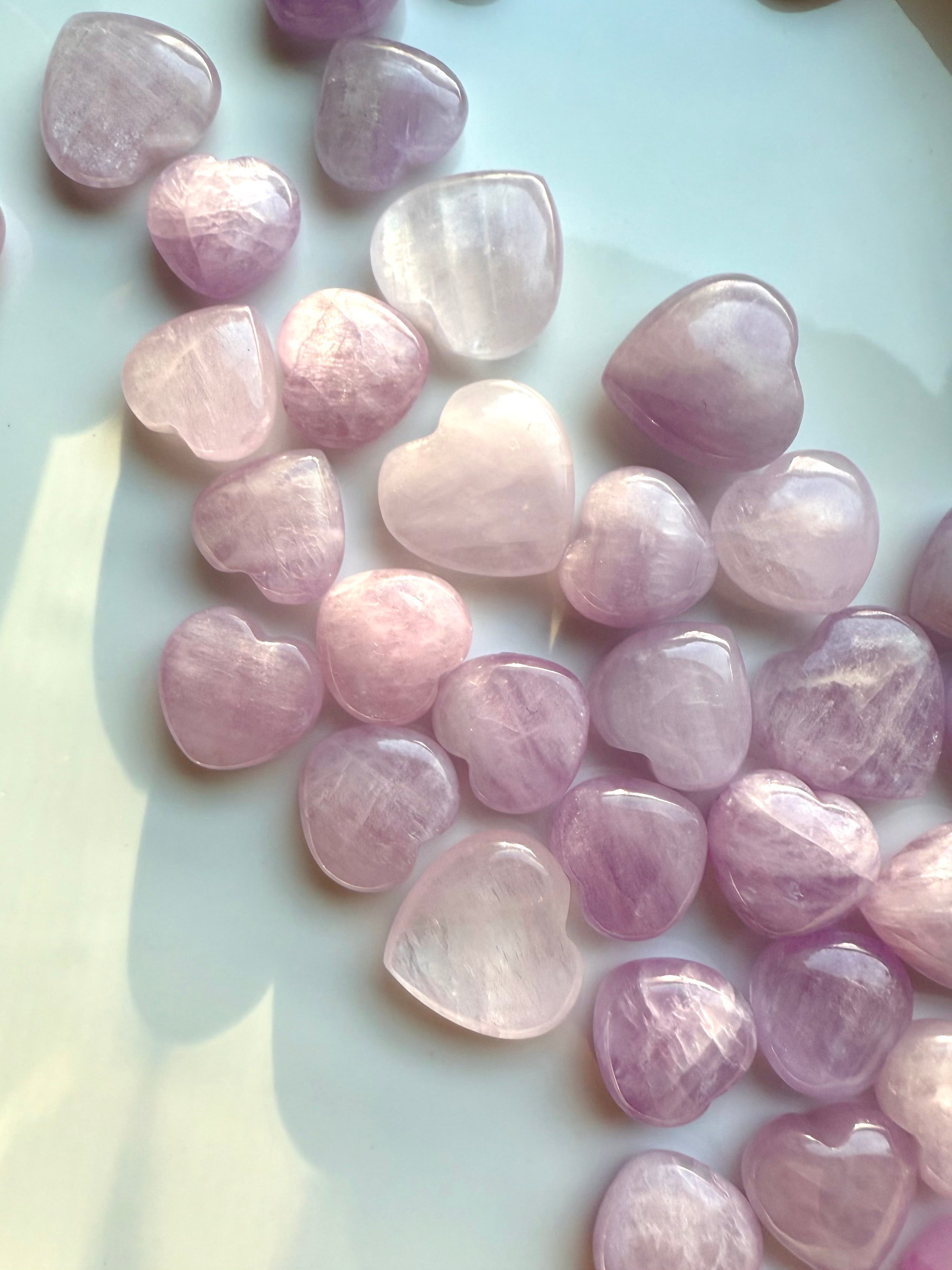 Close-up detail showing shimmer & color variations in Pink Kunzite mini hearts β radiant crystals for love & heart-centered energy.