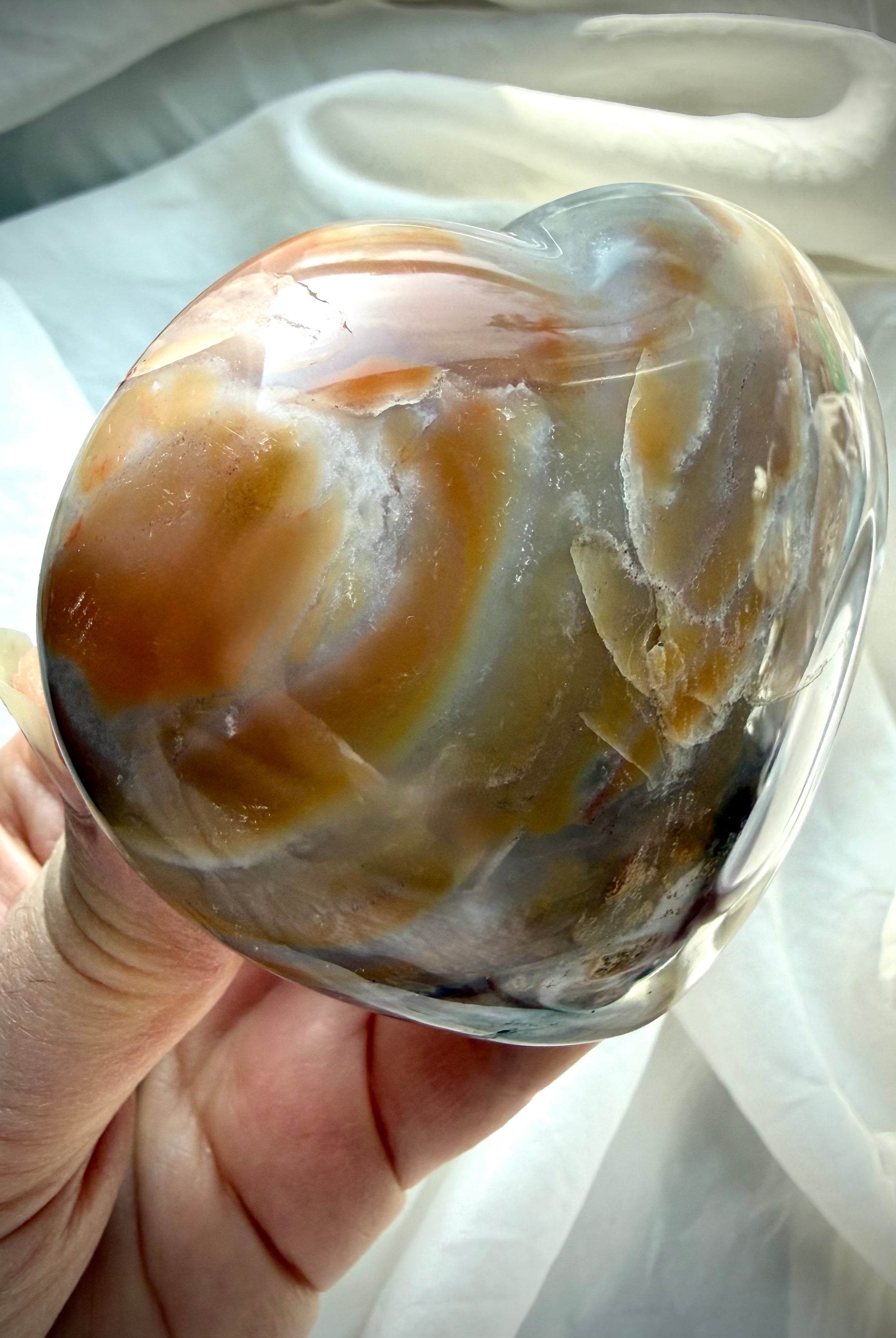 Close up Ocean Jasper heart showing layered agate banding, druzy inclusions and earthy green sea jasper patterning