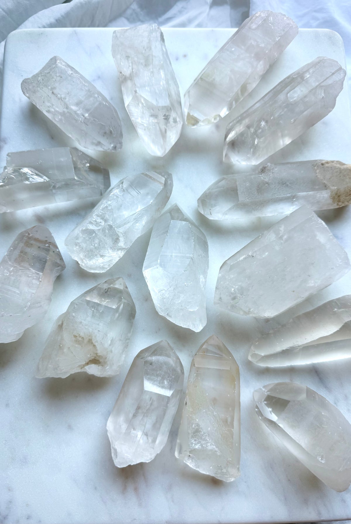 Chunky Lemurian Quartz points from Brazil showing varied sizes, rough natural formations, cloudy inclusions, and terminations