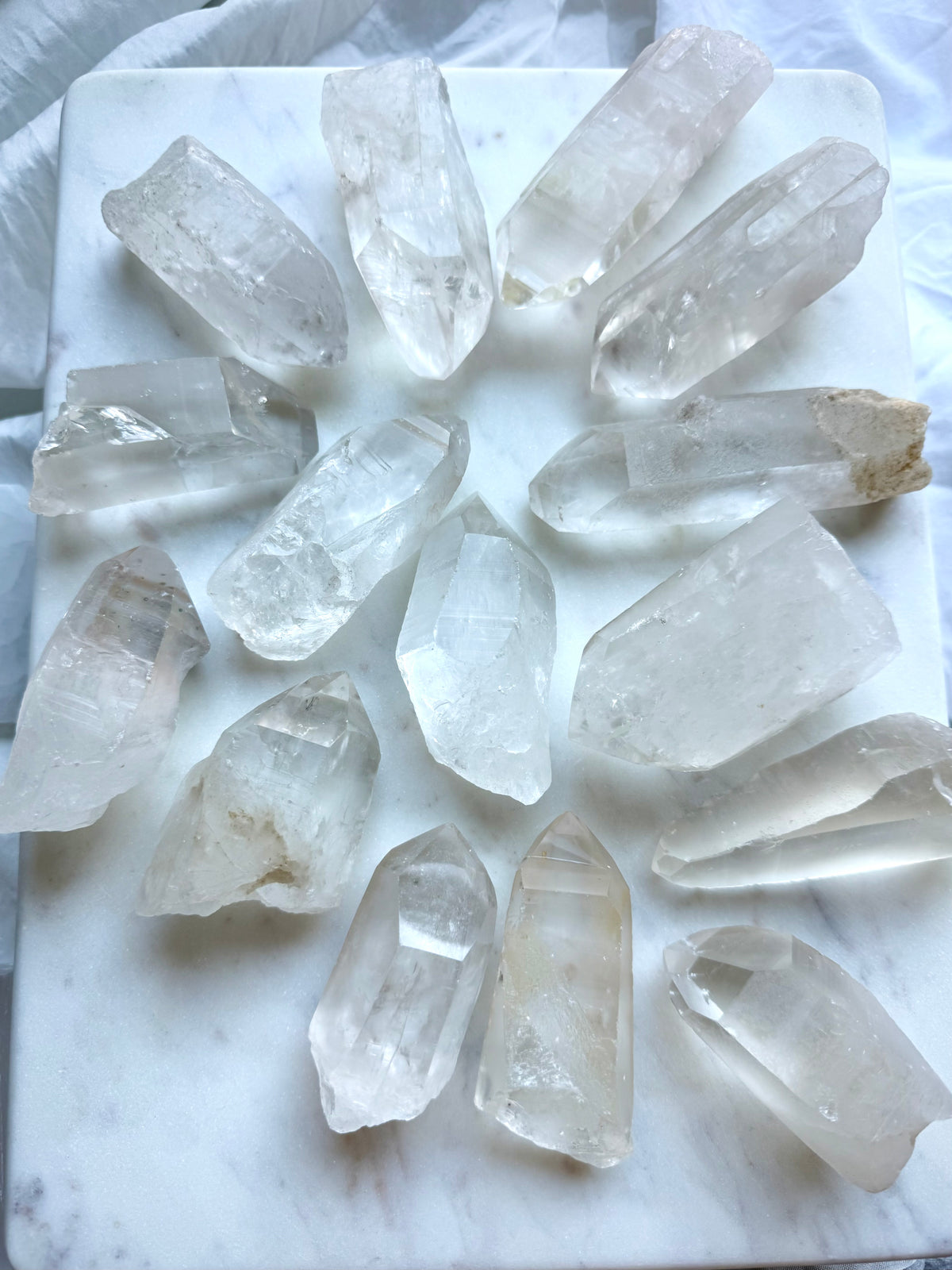 Chunky Lemurian Quartz points from Brazil showing varied sizes, rough natural formations, cloudy inclusions, and terminations