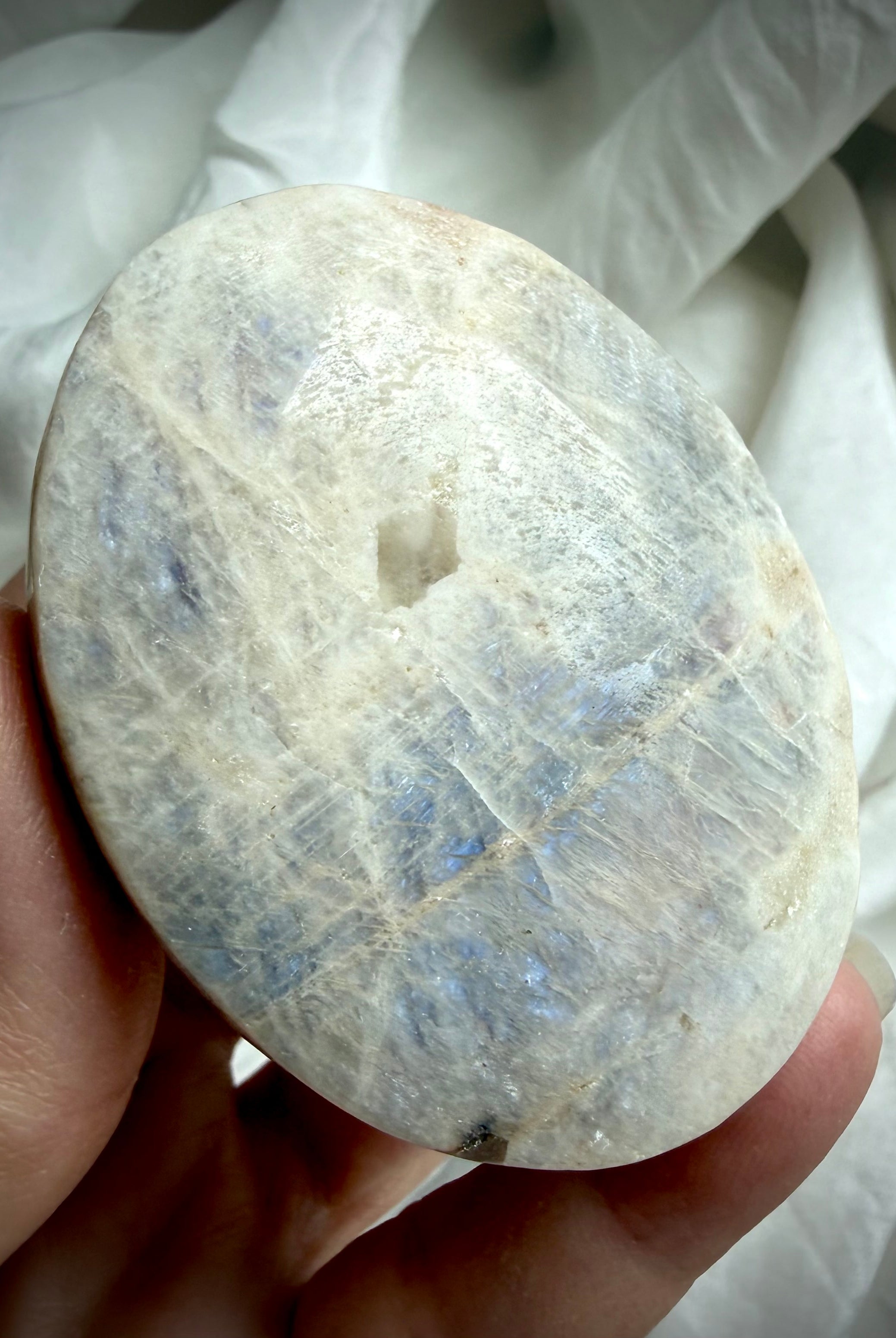 smooth russian moonstone palm stone with silvery sheen and calming lunar energy