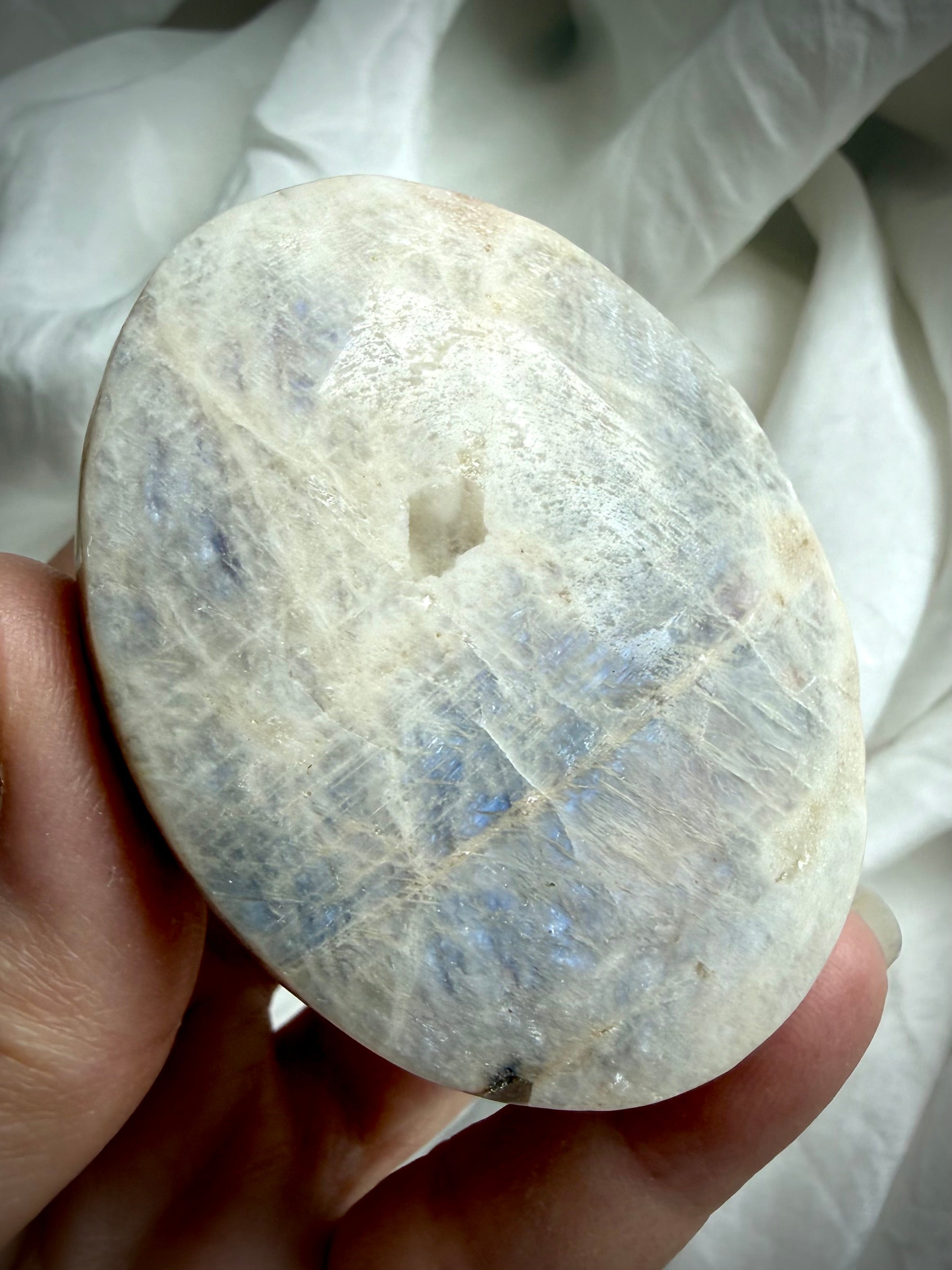 smooth russian moonstone palm stone with silvery sheen and calming lunar energy