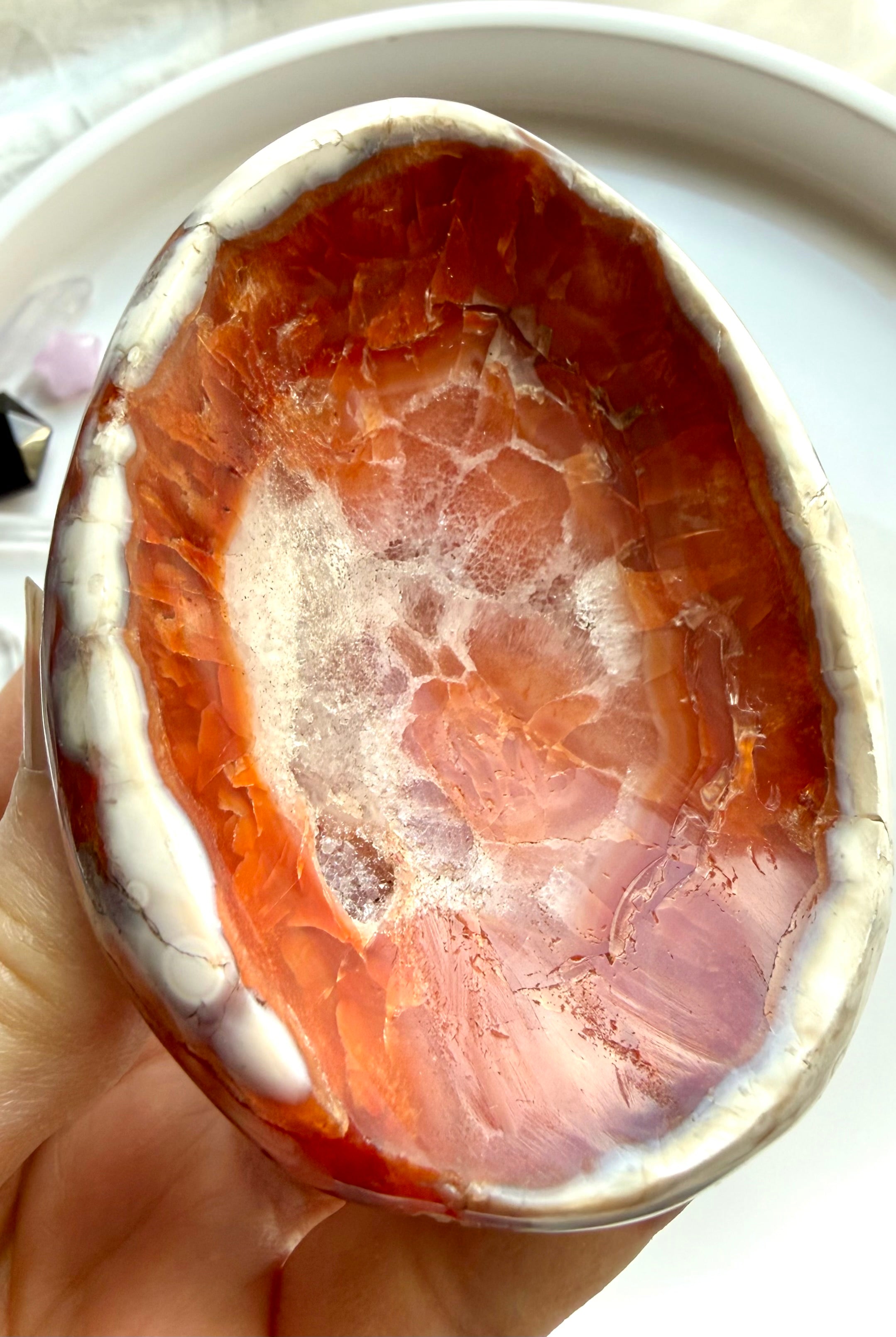 natural carnelian stone dish with white quartz druzy inclusions and polished finish in hand
