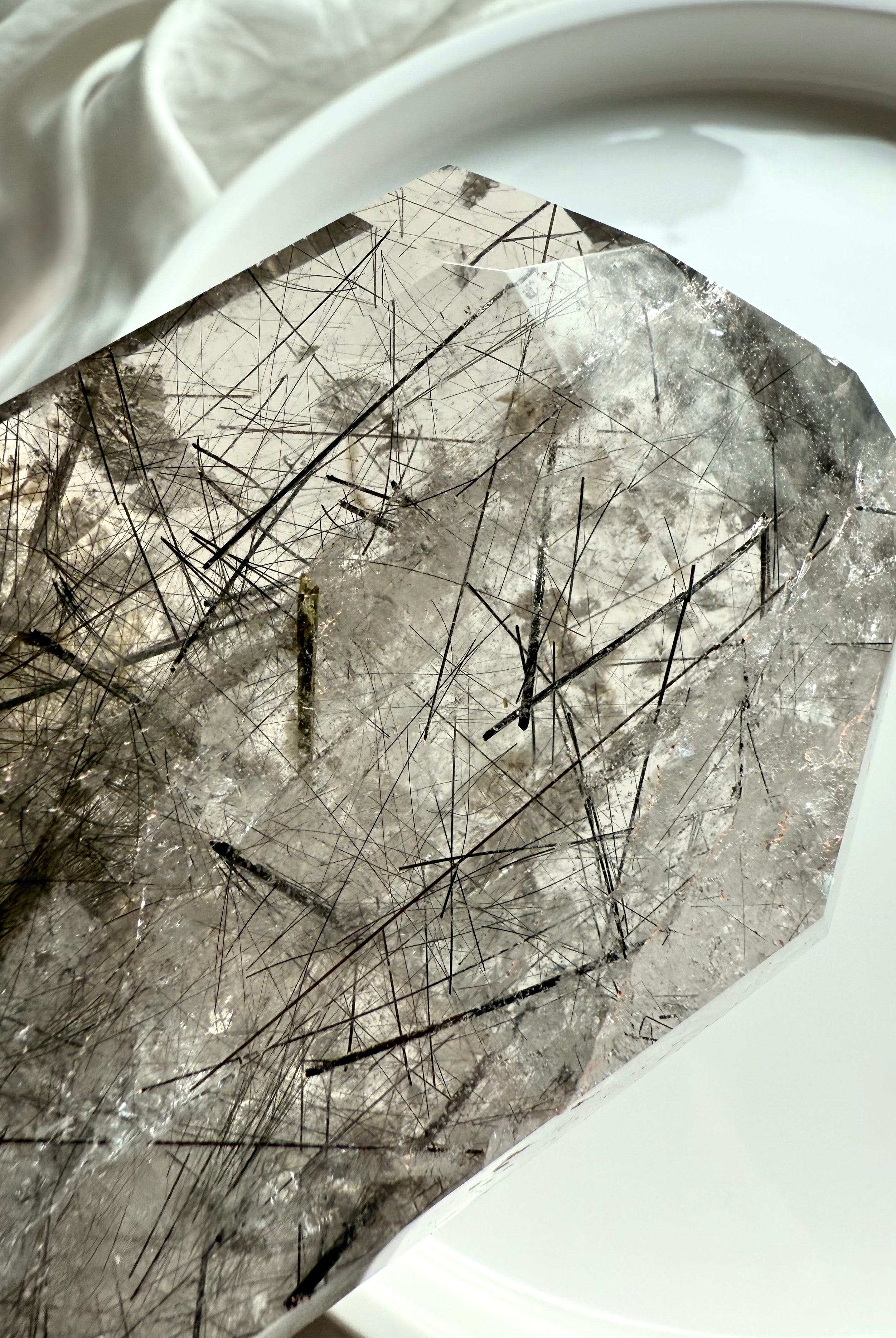 Tourmalinated Quartz tower, closeup of the tip showing fine needle-like black tourmaline inclusions