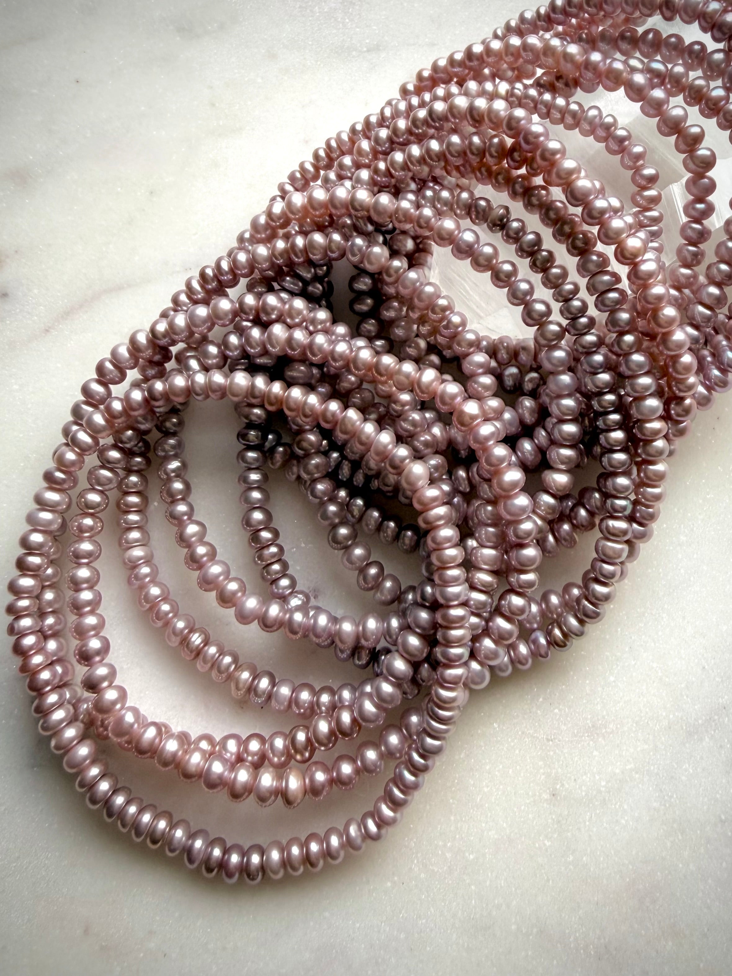 pink freshwater pearl bracelets with silvery lilac tones, natural luster pearl jewelry stack, heart chakra bracelet for love and elegance