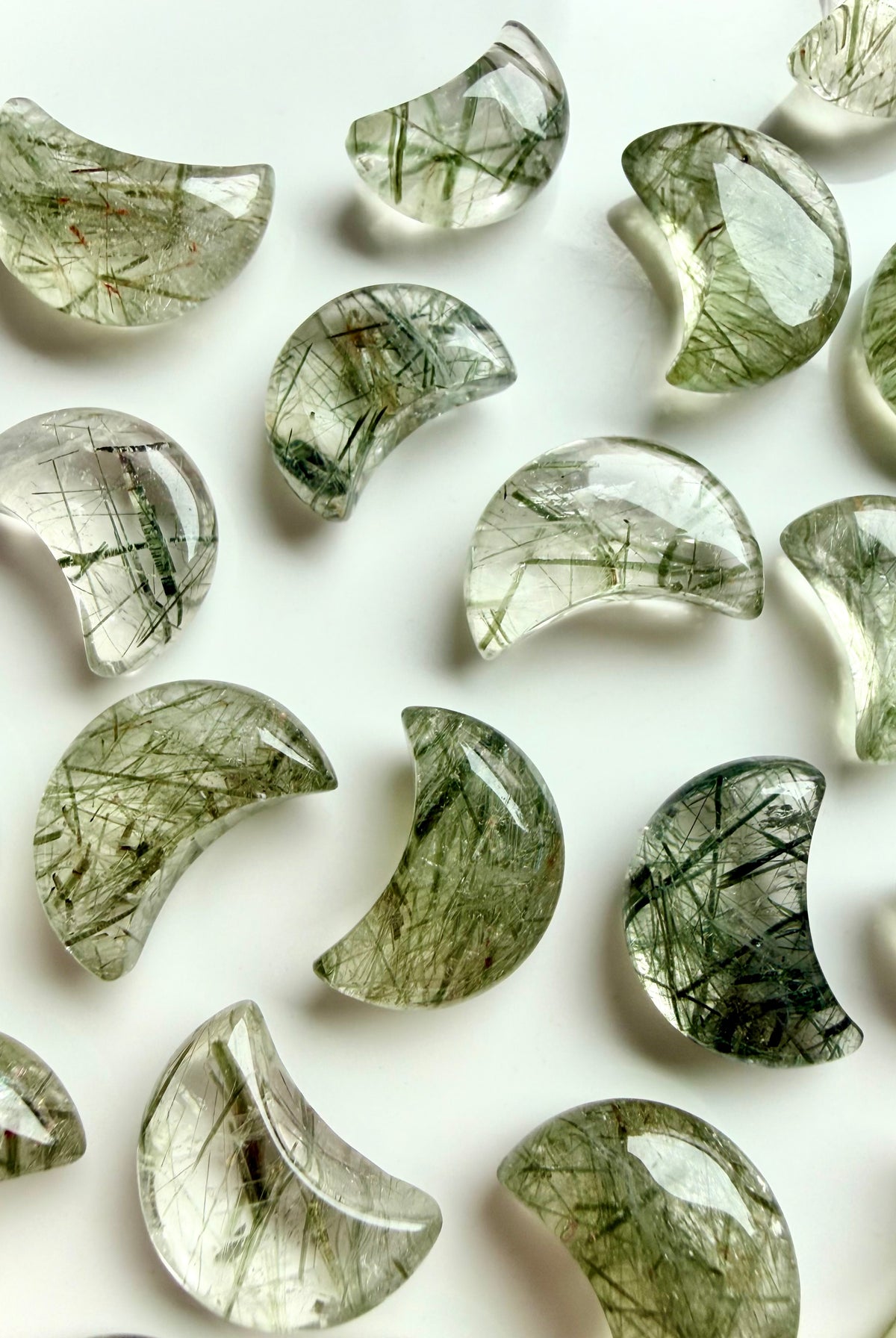 Green Tourmaline in Quartz crescent moons with varied green inclusions and natural patterns in polished crystal carvings
