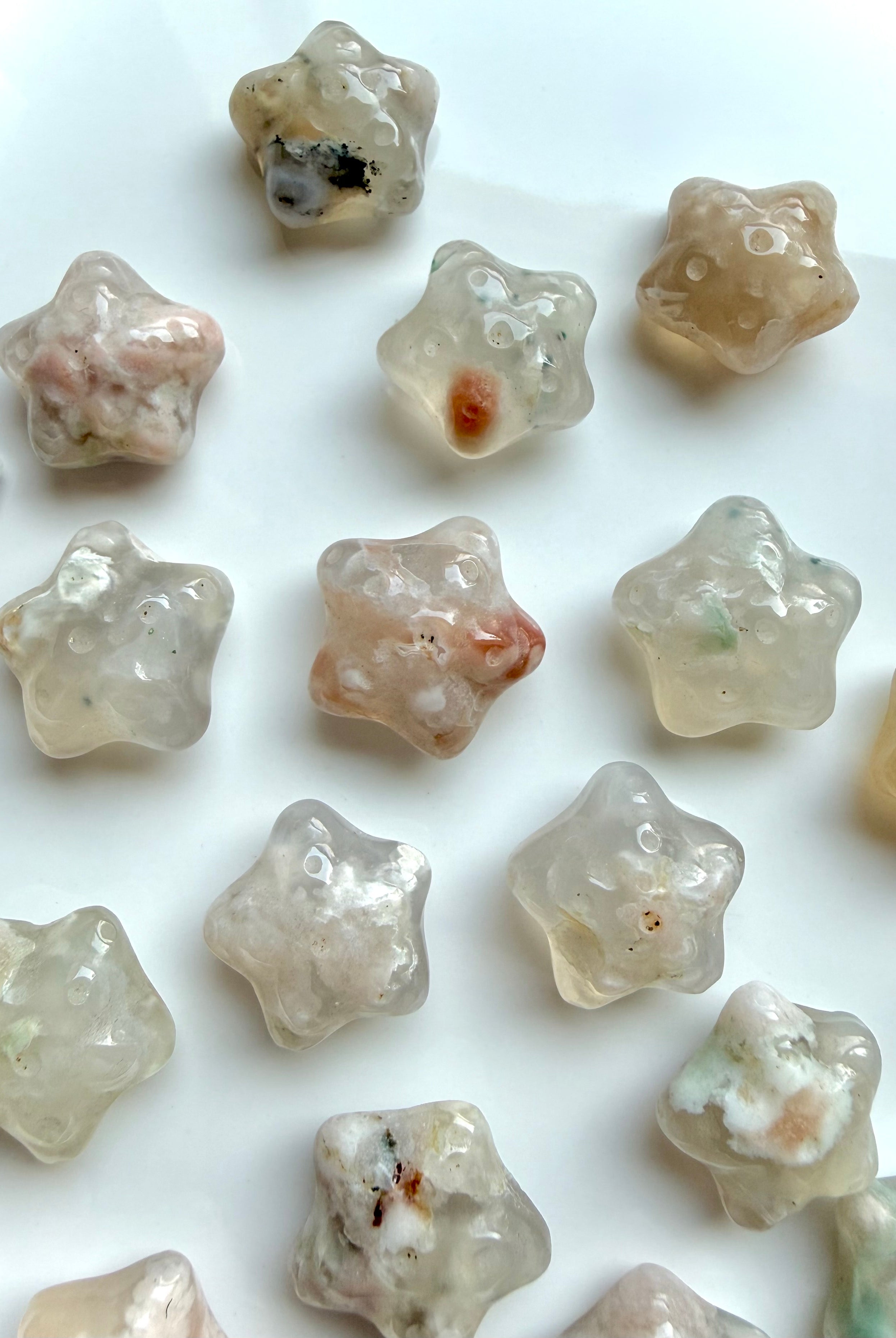 mini Flower Agate starfish crystals with soft pink, cream, and peach hues for heart chakra healing and new beginnings