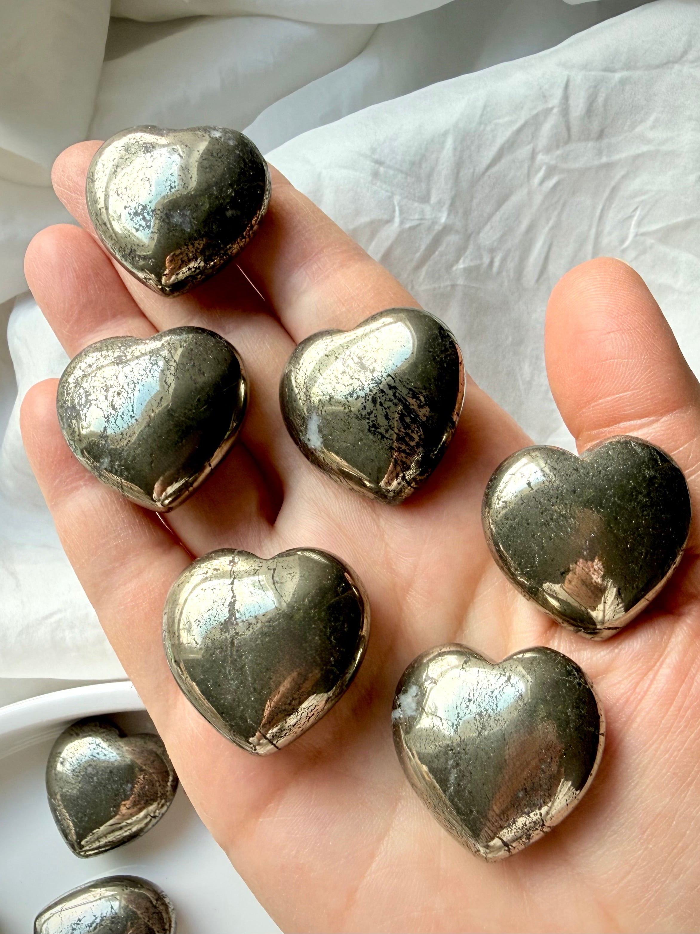 Close-up of Pyrite hearts with natural metallic texture, abundance crystal associated with solar plexus energy