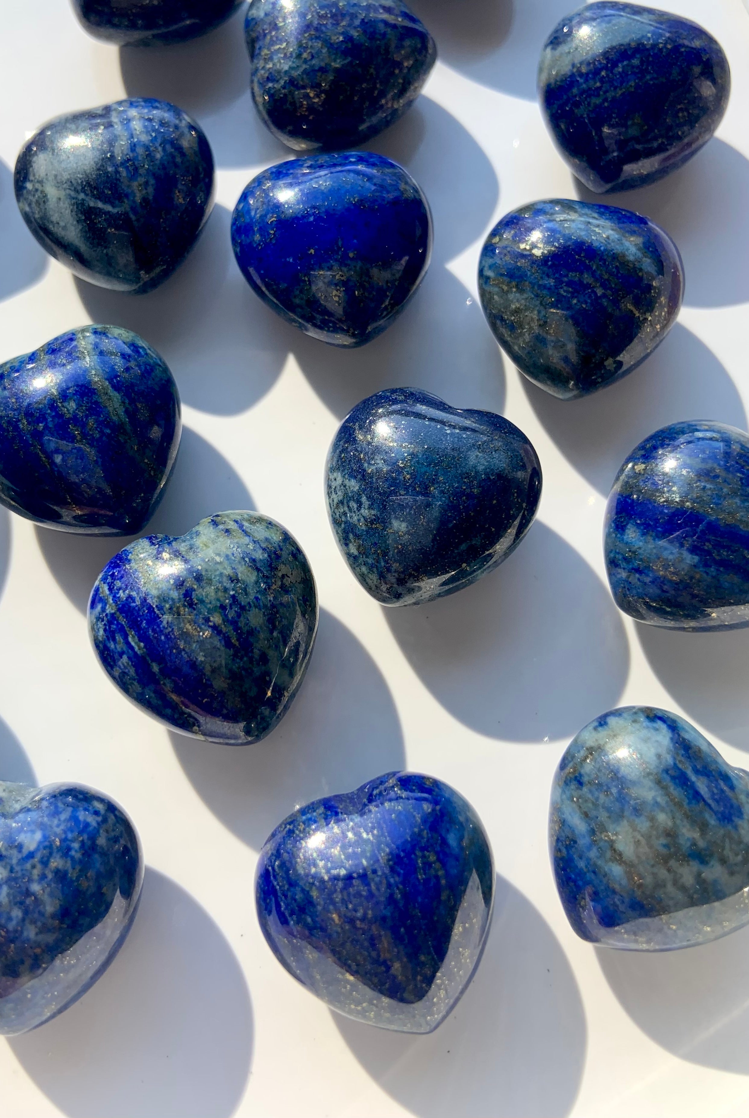 A close up view our mini sized, blue Lapis Lazuli Hearts with sparkling pyrite inclusions
