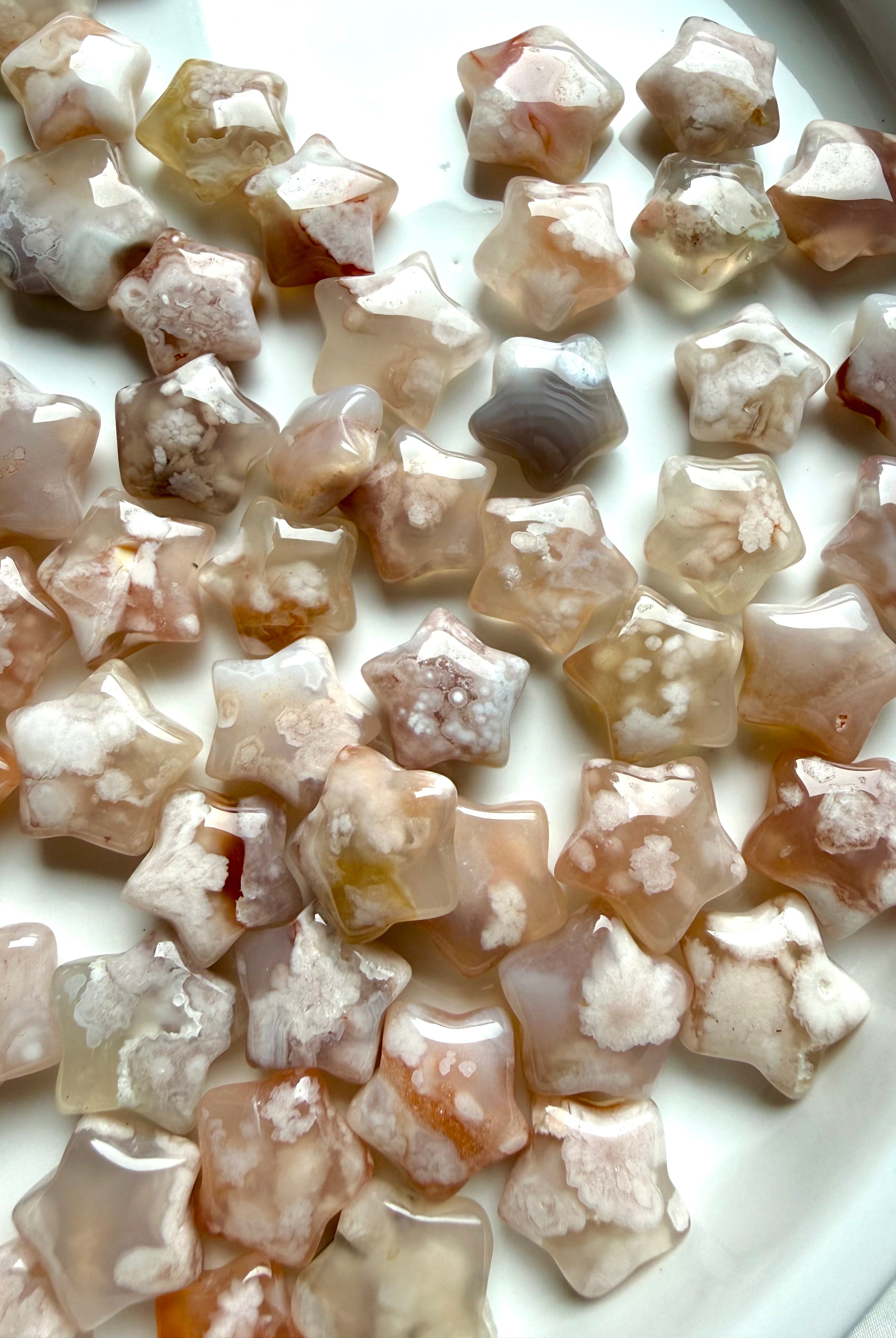 Mini Flower Agate crystal stars with blooming floral plumes in blush pink, cream, and translucent chalcedony tones