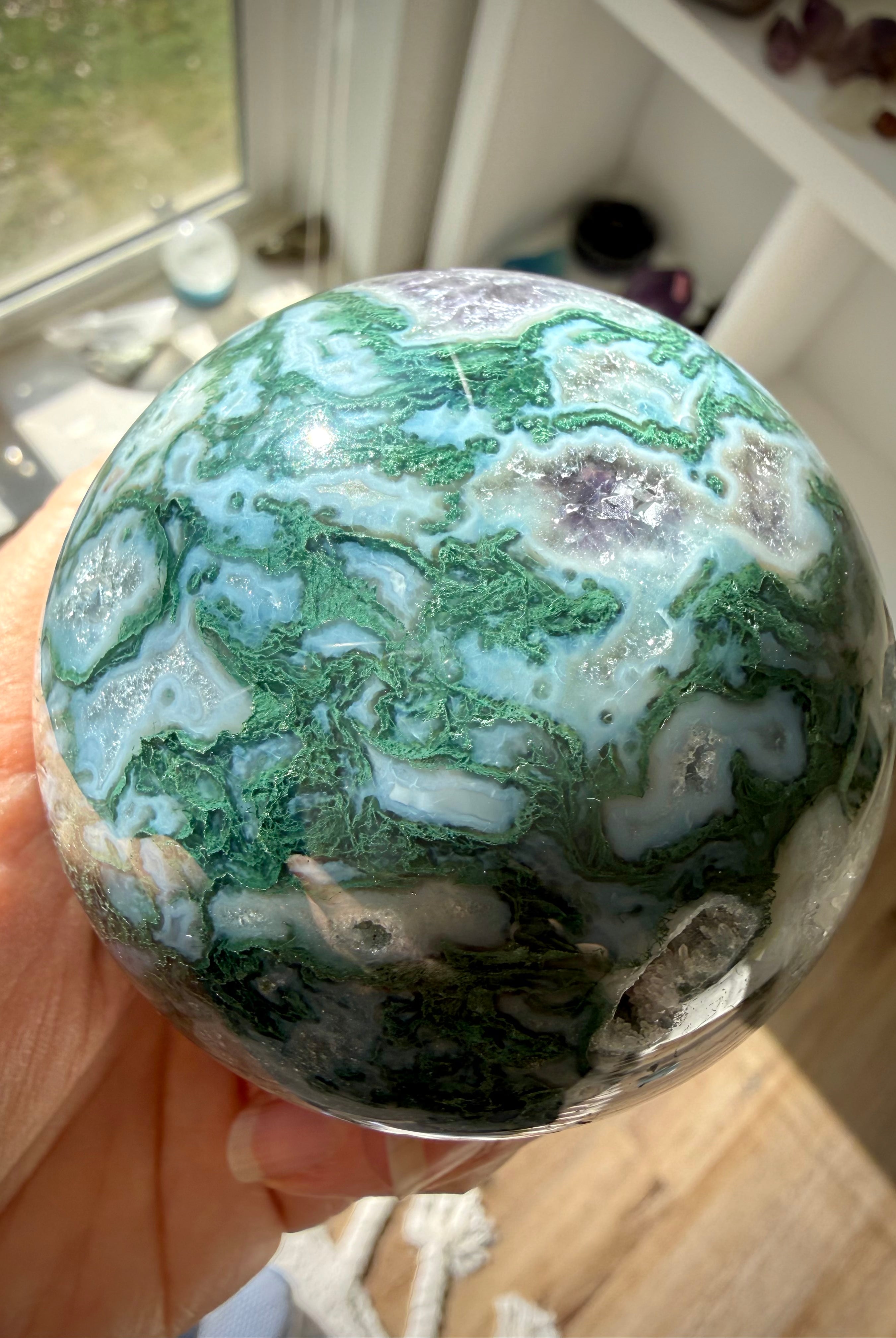 Moss Agate sphere crystal ball with unique green patterns, Quartz details, and Amethyst formations