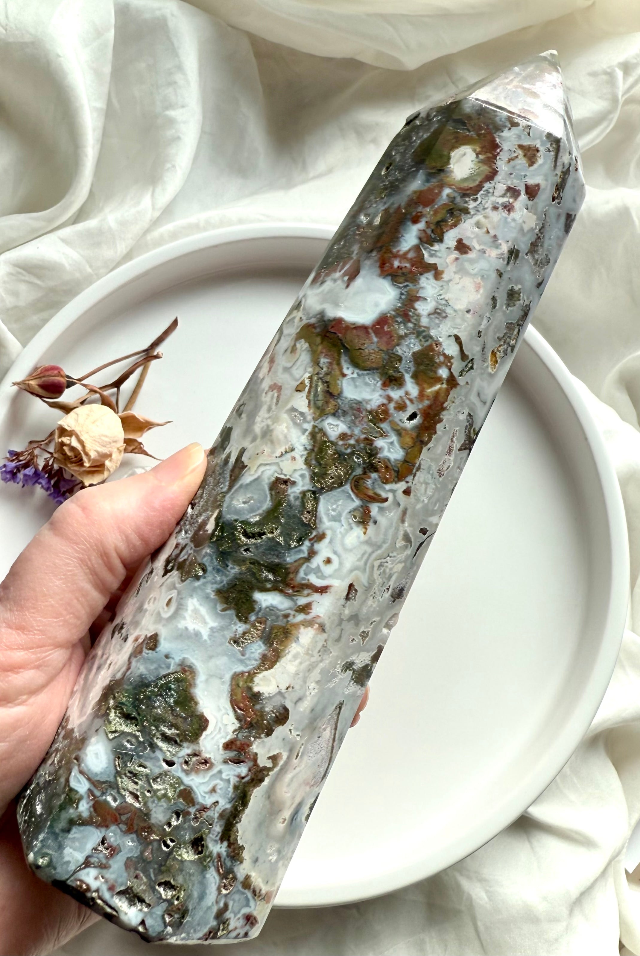 Cosmic Ocean Jasper crystal tower held in hand, highlighting natural patterning, grounding textures, and soothing ocean colors