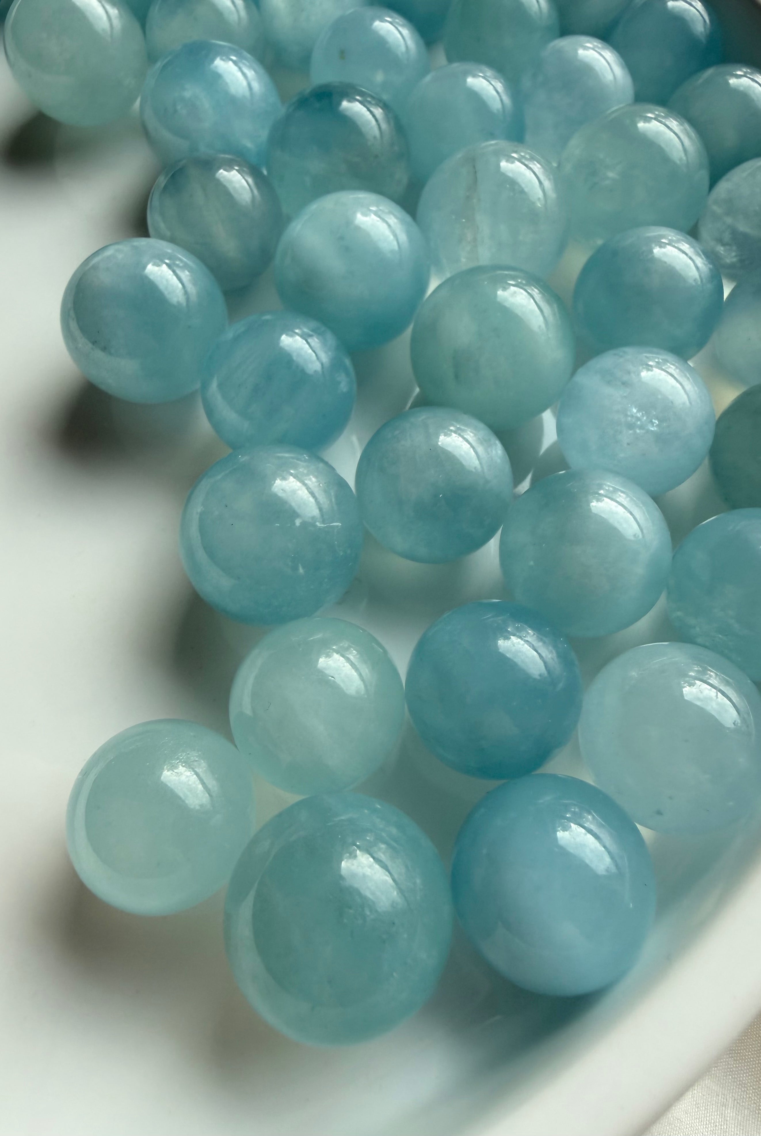 Mini Aquamarine crystal spheres in luminous ocean blue – polished March birthstone crystal balls