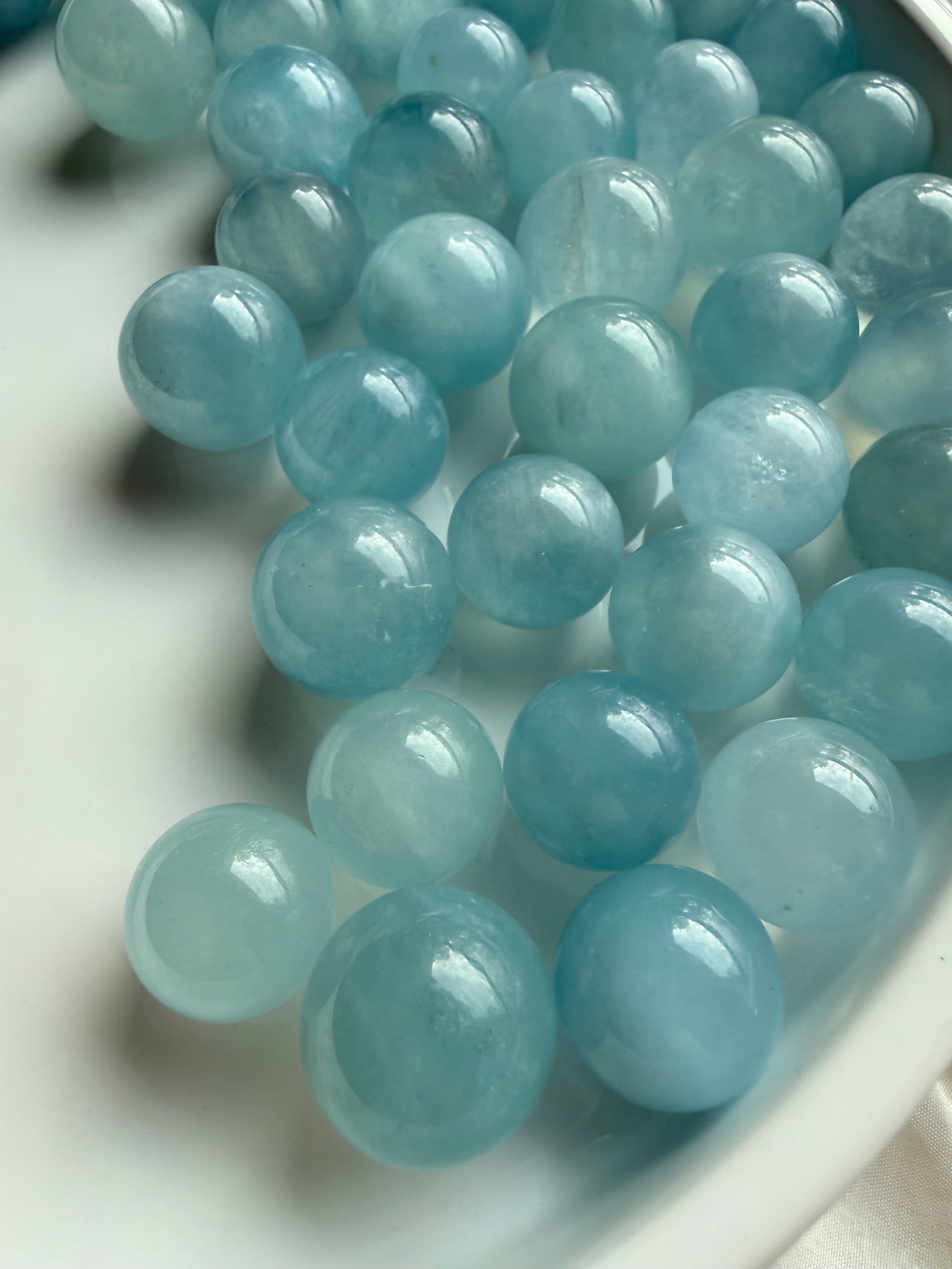 Mini Aquamarine crystal spheres in luminous ocean blue – polished March birthstone crystal balls